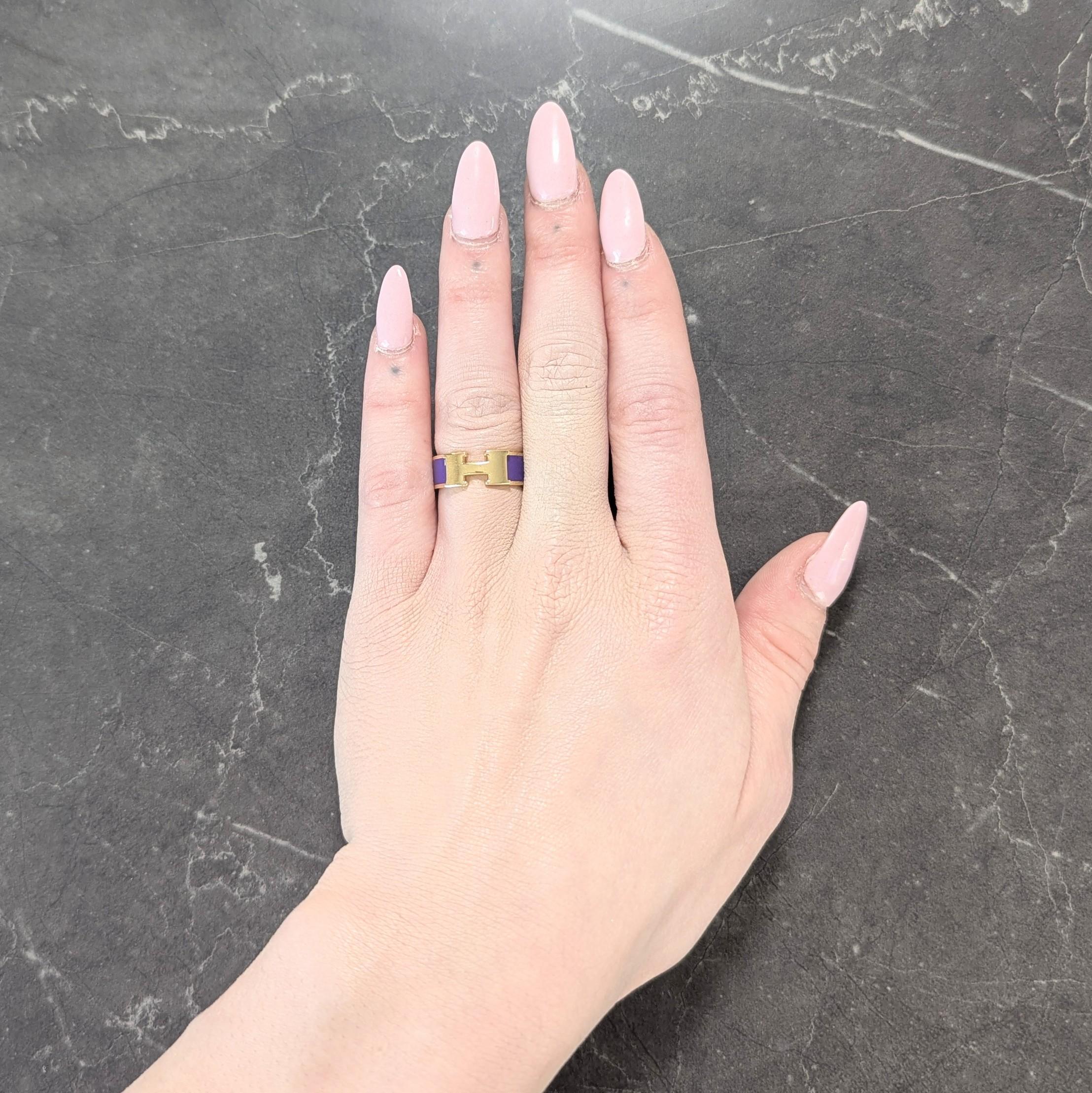 Designed as a gold band centering an 'H' applique
Featuring a channel of opaque purple enamel
Glossy and displaying no loss
With high polish finish
Stamped for 18 karat gold
Circa: 2000s; via the Clic Clac Collection
Ring Size: 6 and not