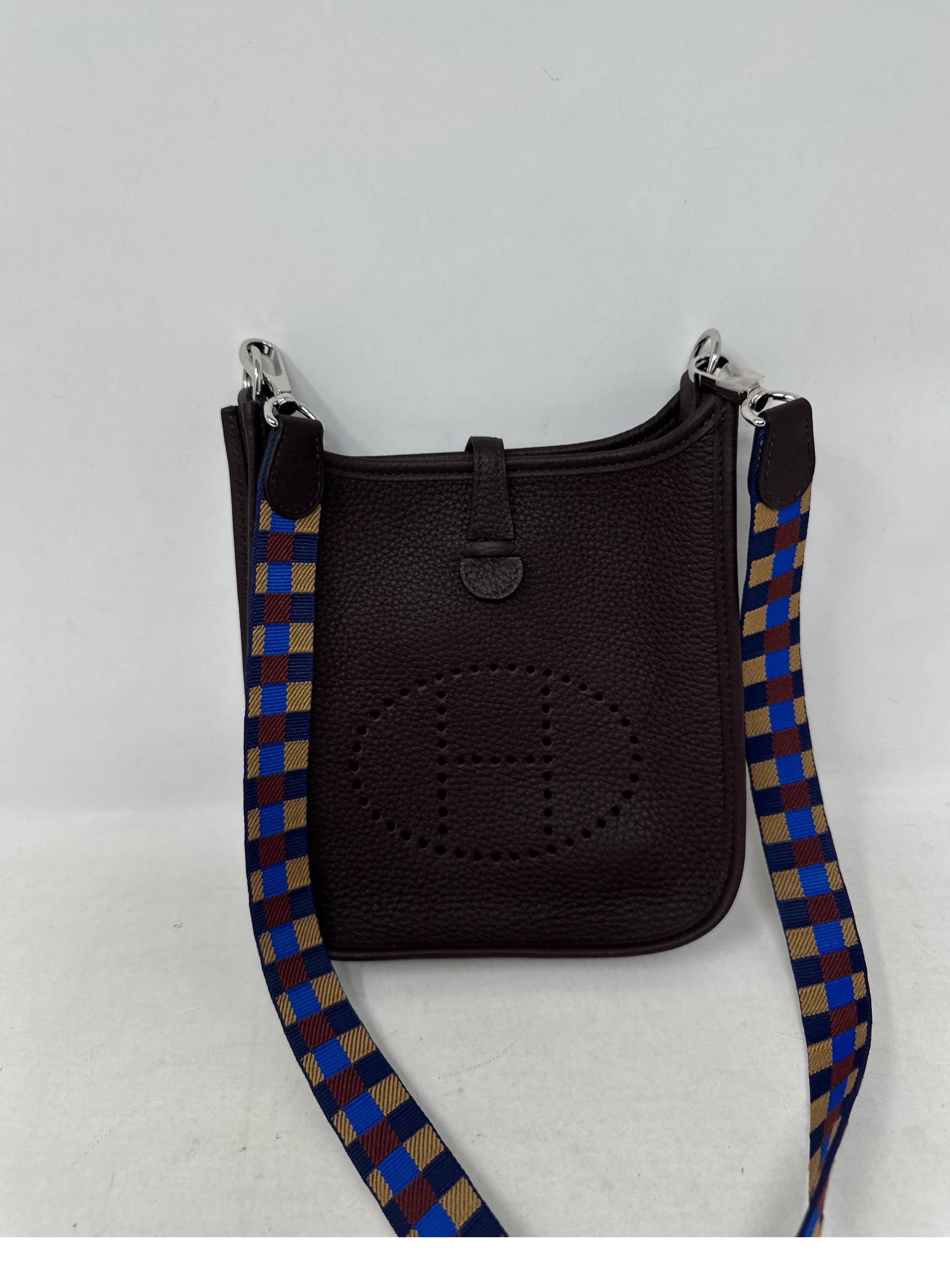 Hermes Dark Purple Evelyne TPM Bag. Excellent like new condition. Mini size Evelyne bag with rare unique strap. Interior clean and mint. Includes multi color strap and dust bag. Guaranteed authentic. 