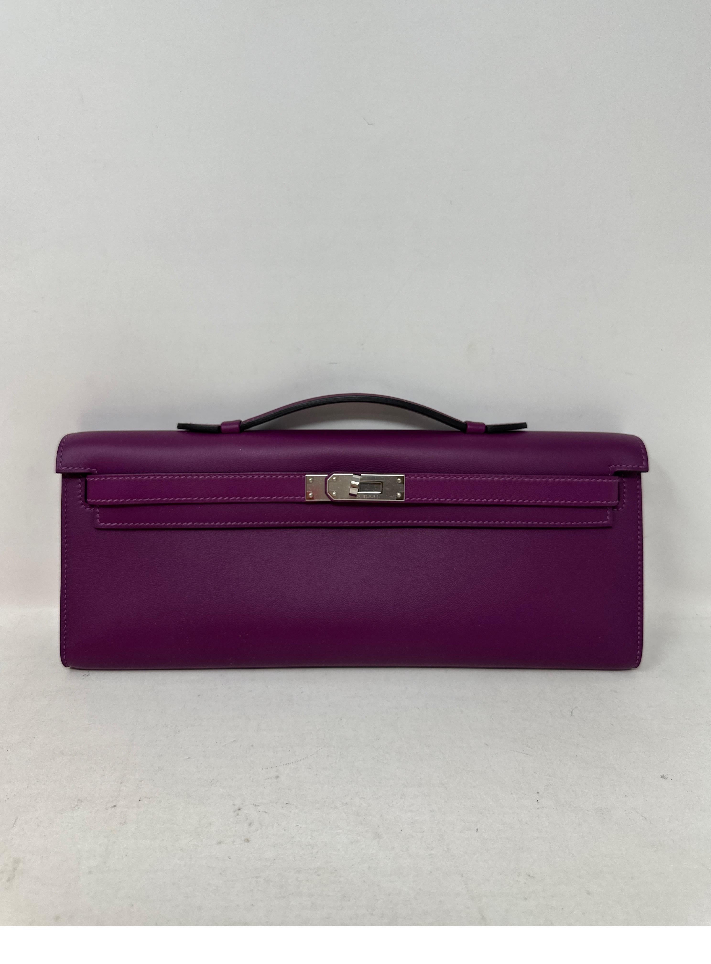 Hermes Purple Kelly Clutch Bag. Excellent condition. Looks like new. Plastic is still on the hardware. Rich purple color. Palladium silver hardware. Retired Kelly clutch. Great investment bag. Includes original box and dust bag. Guaranteed