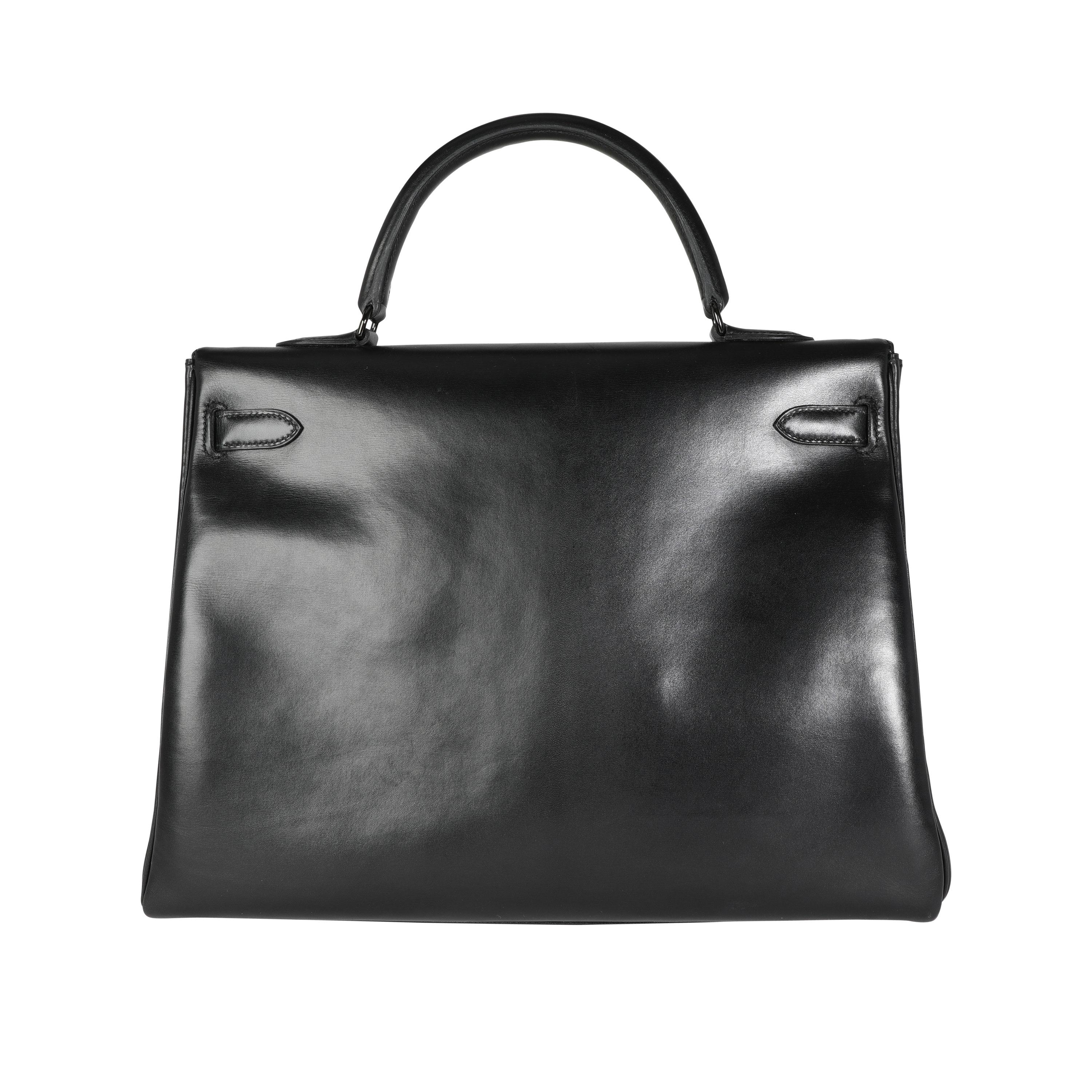 Listing Title: Hermès Rare Black Box Calf So Black Retourne Kelly 35 PVD
SKU: 115910
Condition: Pre-owned (3000)
Handbag Condition: Very Good
Condition Comments: Very Good Condition. Plastic on some hardware. Light scuffing to exterior due to nature