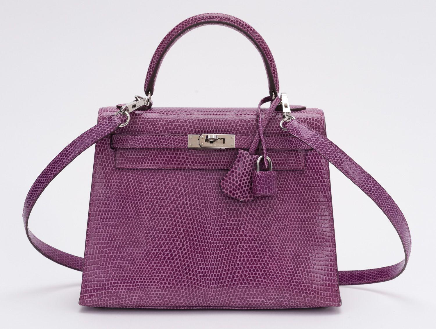 Hermès Kelly 25 en cuir de lézard en violet. Pièce de collection absolue, super rare. Le timbre dateur indique un N. Le sac est composé de  livret, veste de pluie, petite et grande housse de protection, boîte d'origine.