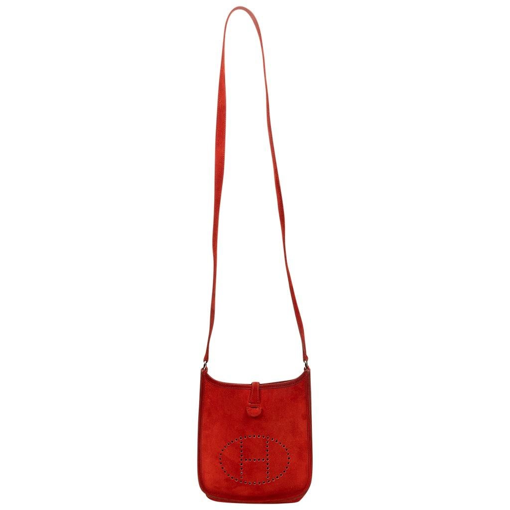 Photos do not do this beauty justice. The shade of red and the size combined with the suede make this bag feel so special and unique. With red suede leather and a tonal leather strap, the signature stamped out H to the front face, with silver tone