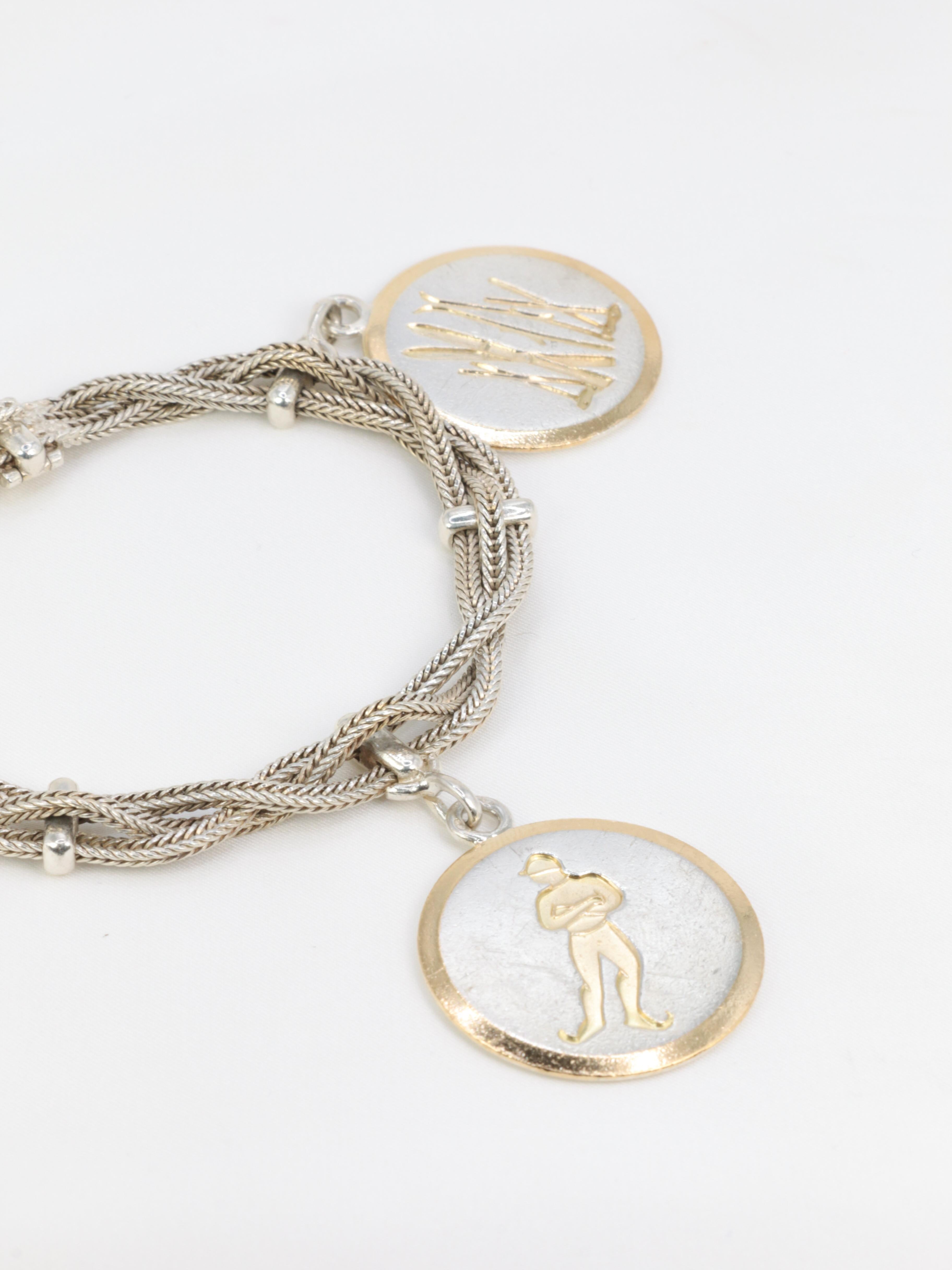 Partially vermeiled silver bracelet featuring three braided chains enhanced by three ski-themed medals. The first features two pairs of skis, the second a skater and the last a ski slope.
French work from the 1950s.
Signed HERMES and trace of a