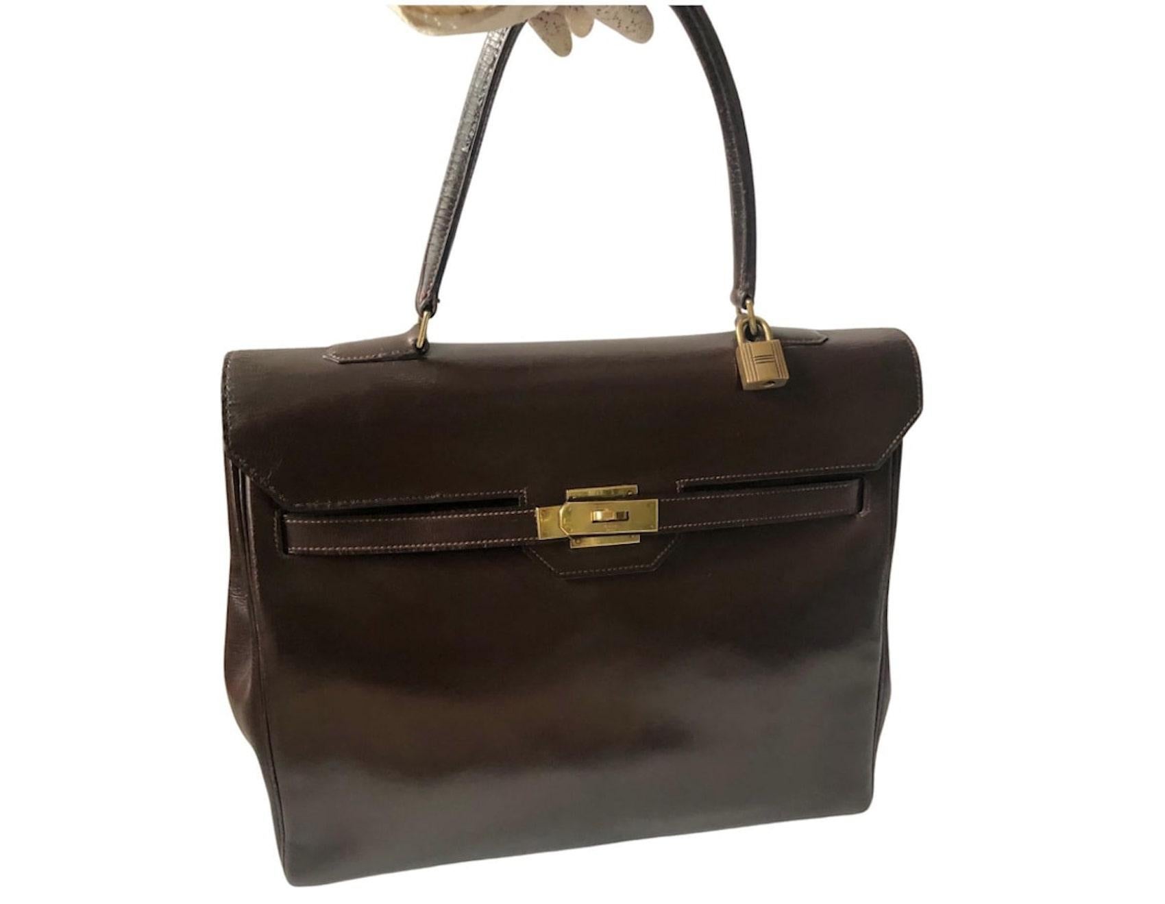 A 1969 Hermès brown box leather Monaco Kelly 30 tote bag featuring a fold-over top with a gold tone push-lock closure, a single top handle, plated gold-tone. Interior with one double patch pockets and one patch pocket, interior is in brown leather.