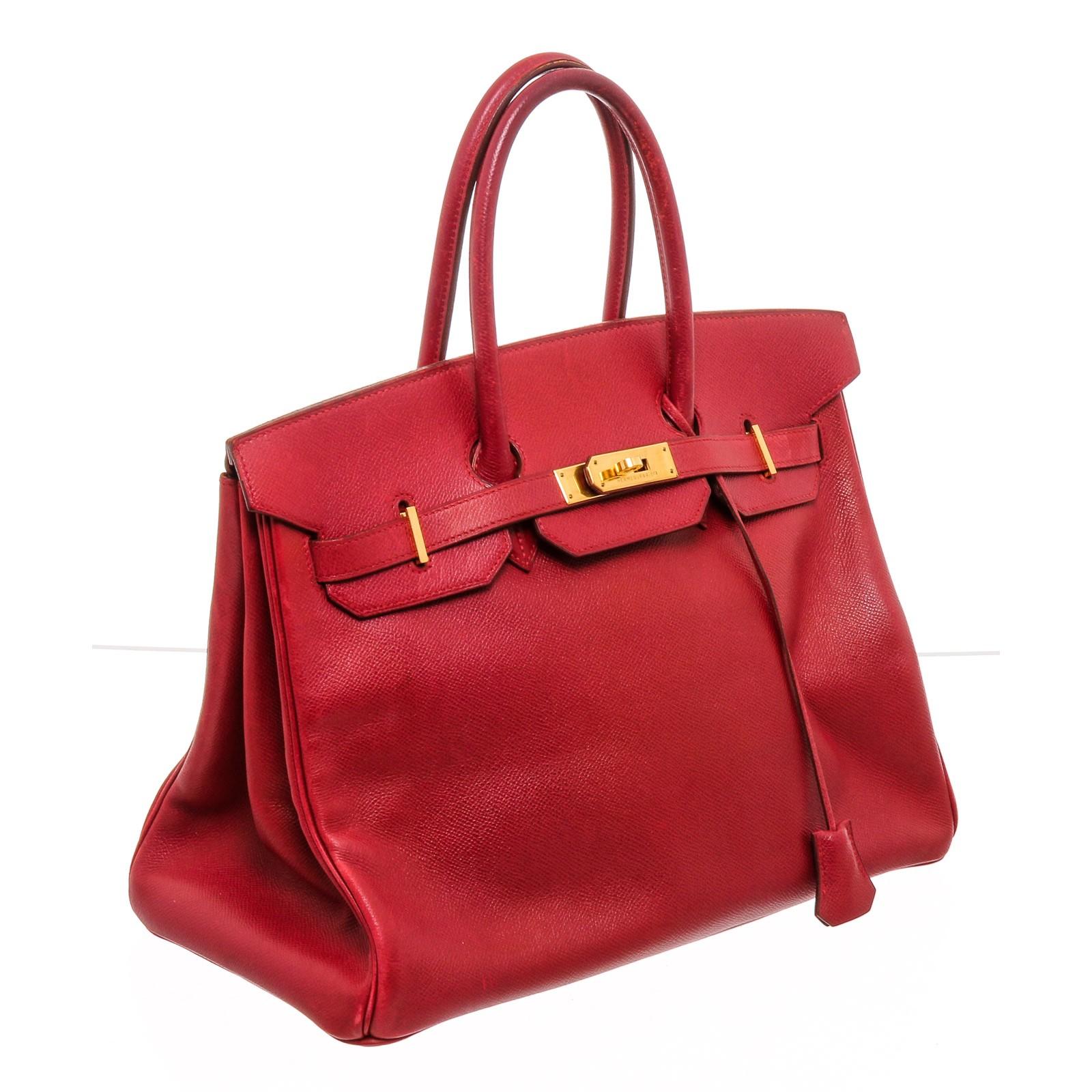 Red Ardennes leather Hermès Birkin 35 with gold-plated hardware, dual rolled top handles, sangle expansions at sides, foil stamped logo at flap underside, tonal leather lining, dual pockets at interior wall; one with zip closure and turn-lock