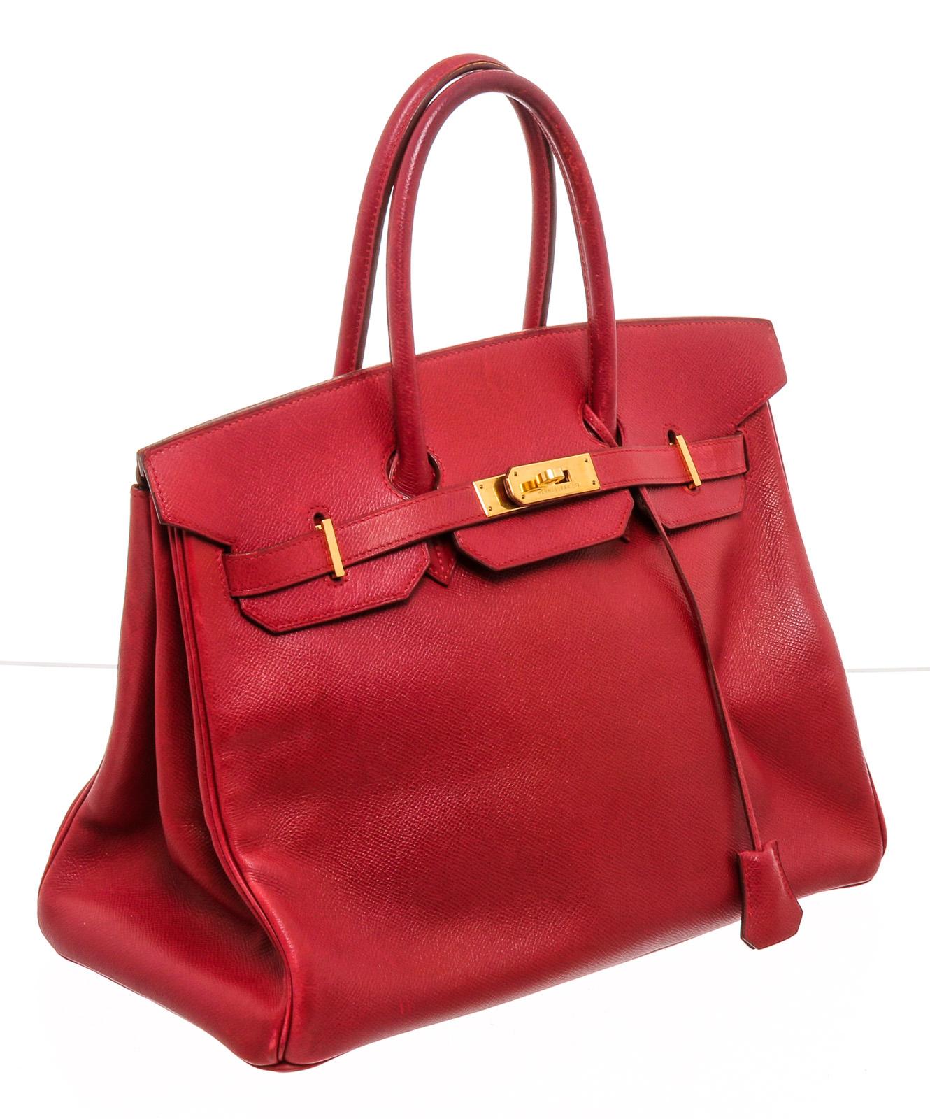 Red Ardennes leather Hermès Birkin 35 with gold-plated hardware, dual rolled top handles, sangle expansions at sides, foil stamped logo at flap underside, tonal leather lining, dual pockets at interior wall; one with zip closure and turn-lock