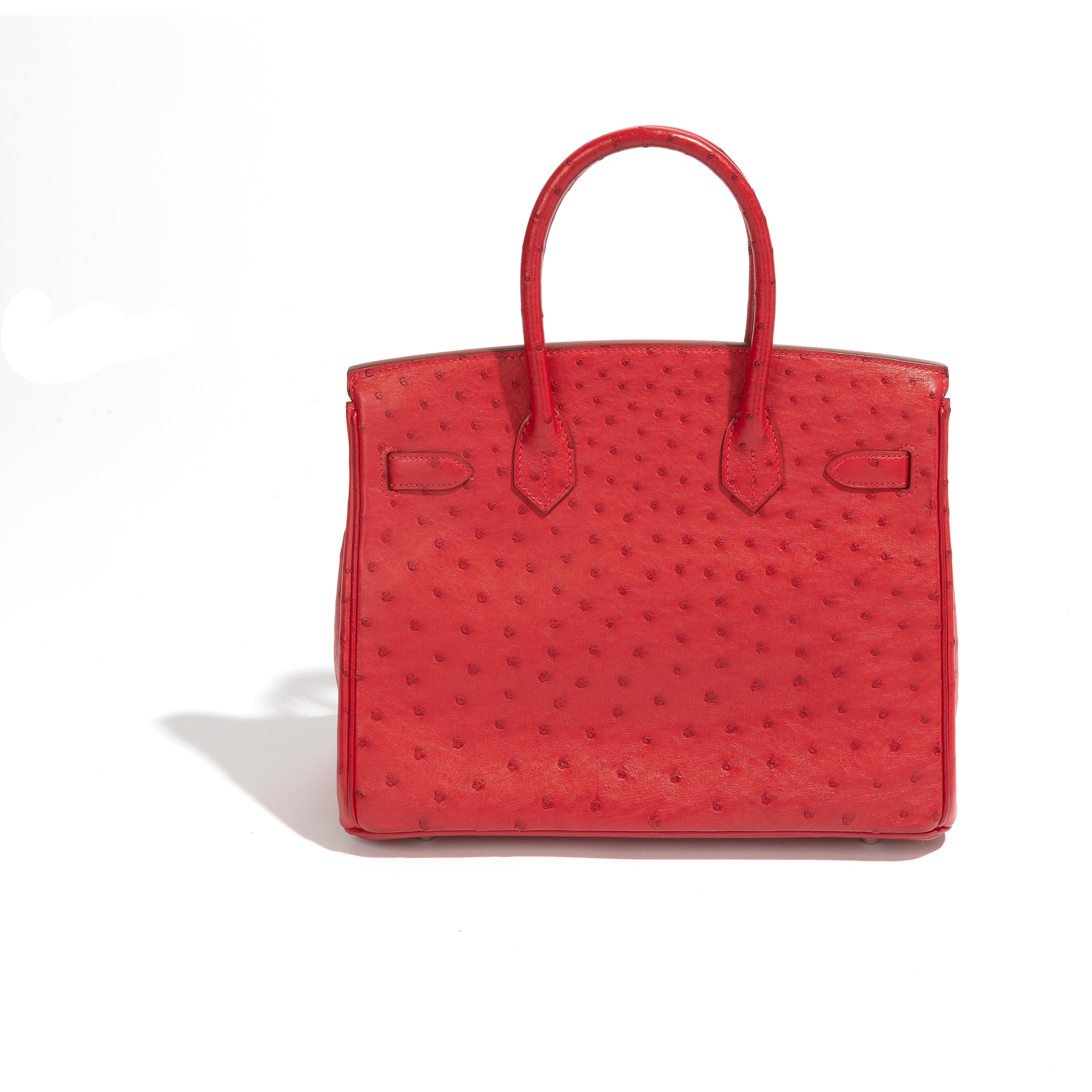 This Birkin 30 is a highly sought-after piece crafted from premium quality red leather and finished with stunning palladium hardware. The bag has been well-maintained and is in excellent condition, making it a rare find for any fashion enthusiast.