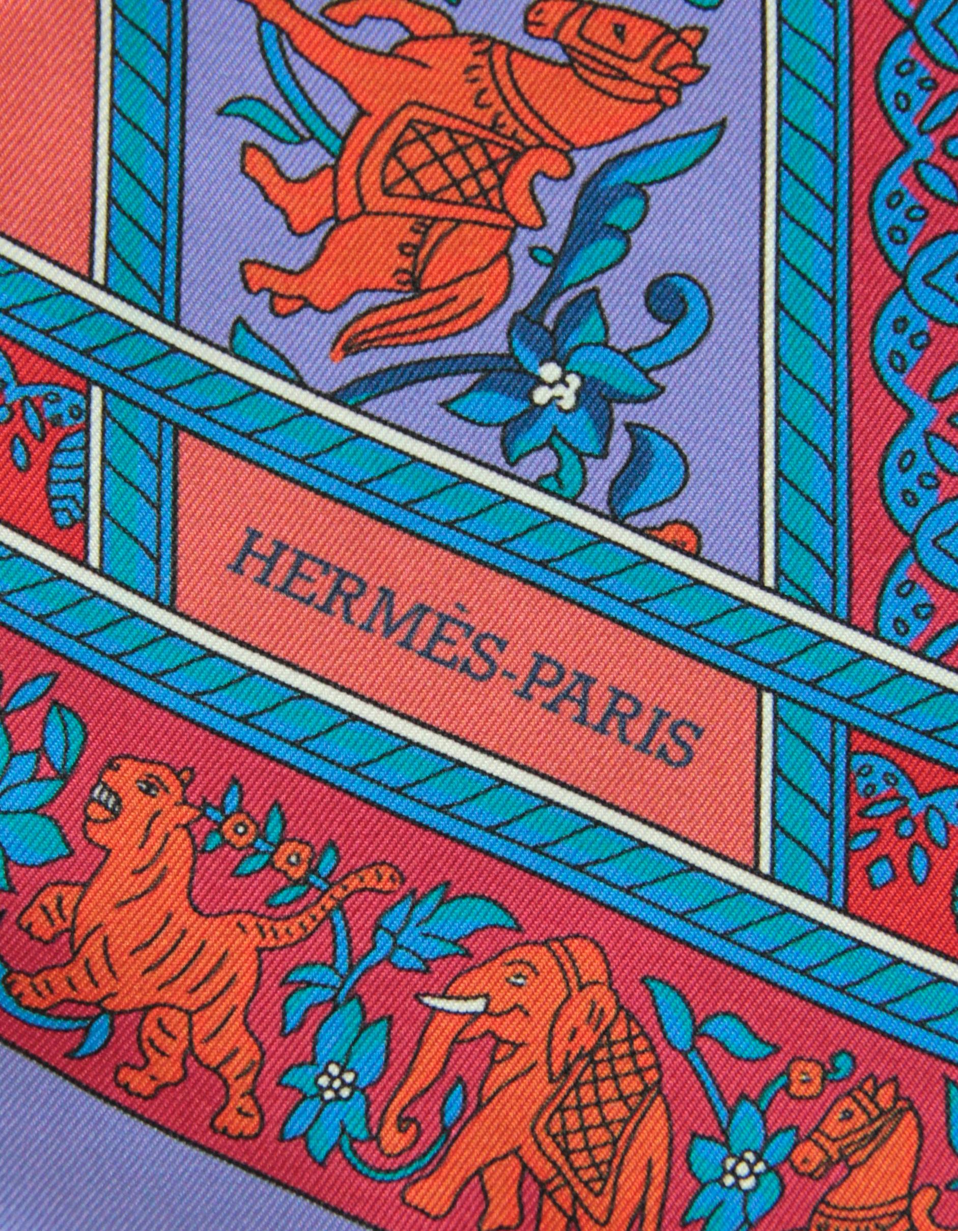 Hermes Red/ Blue Chasse en Inde (Hunt in India) Silk Maxi Twilly Scarf. Print features tigers, elephants, camels, birds and horses being hunted. 
Made In: France
Color: Red, blue, periwinkle
Materials: 100% silk
Overall Condition: Excellent