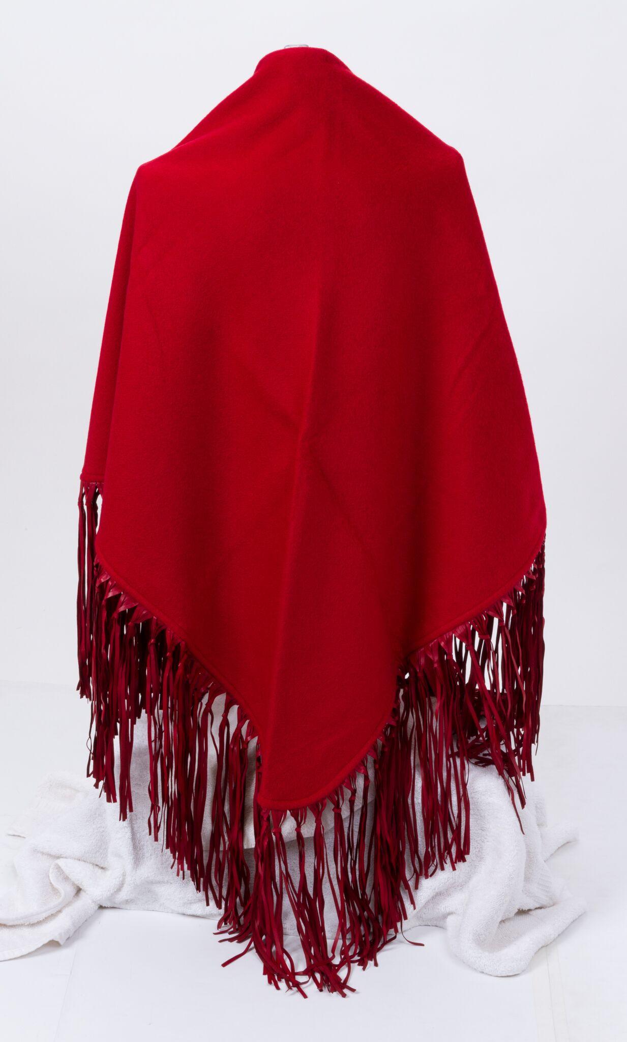 Late 1990s Hermès red cashmere-and-wool shawl with extra-long leather fringe. Brand new in original unworn condition.
70% cashmere/30% wool/leather