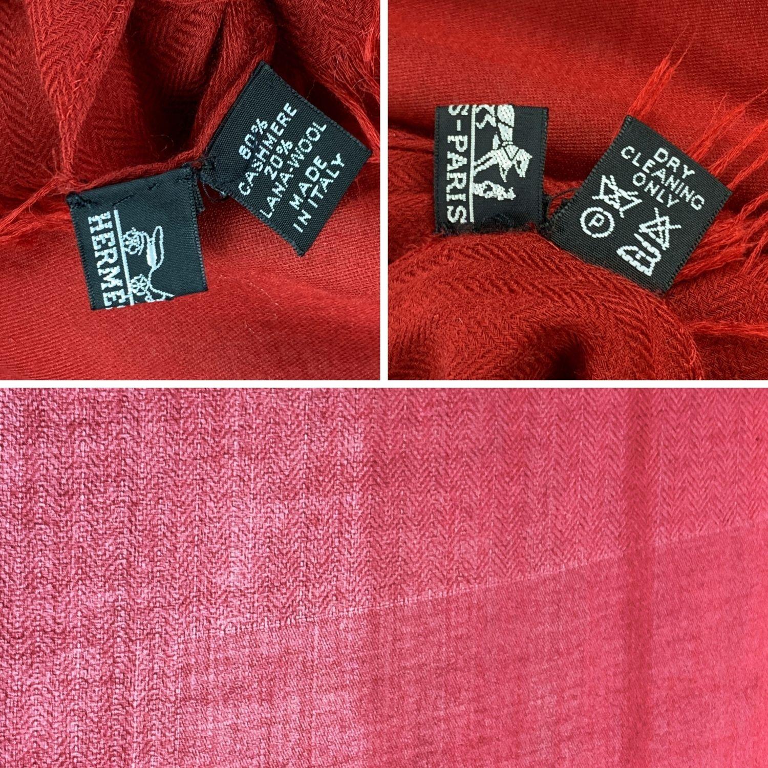 Rare cashmere and wool scarf by Hermes. Red color. Big H pattern in the center. Composition; 80% Cashmere,20% Wool. Fringed hem. Approx. measurements: 60 x 80 inches - 152 x 203. Made in Italy. 'HERMES - Paris' and composition tags are still