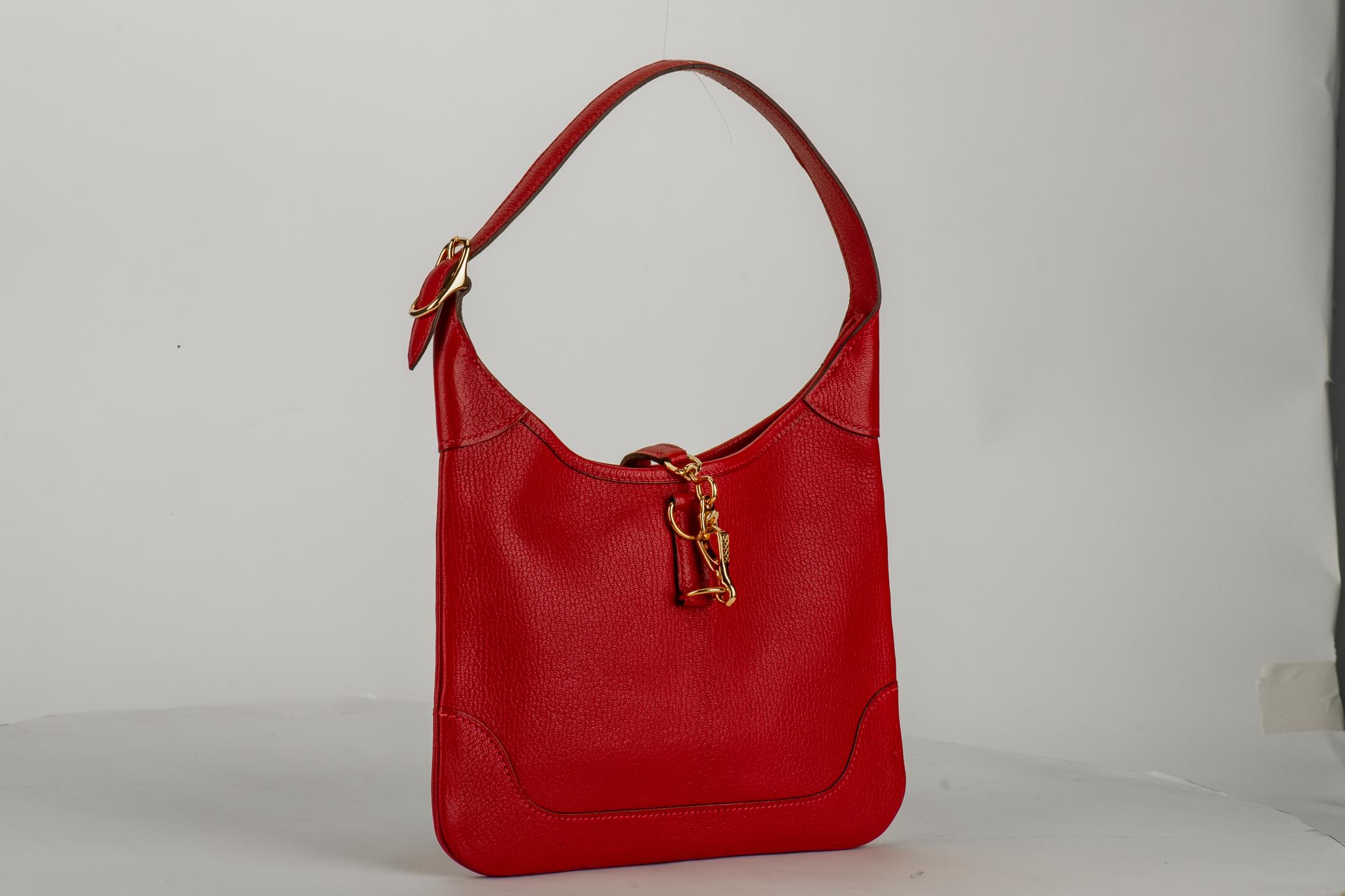Hermes red chevre mini trim shoulder bag with gold tone hardware. Excellent condition. Date stamp H for 2004.