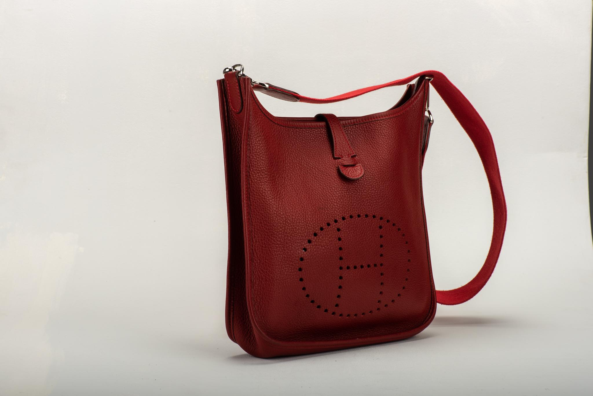 Hermès preowned Evelyne PM in red Clemence leather with palladium hardware. Date stamp J for 2006. Comes with original dust cover. Please refer to photos for condition. Minor wear.
