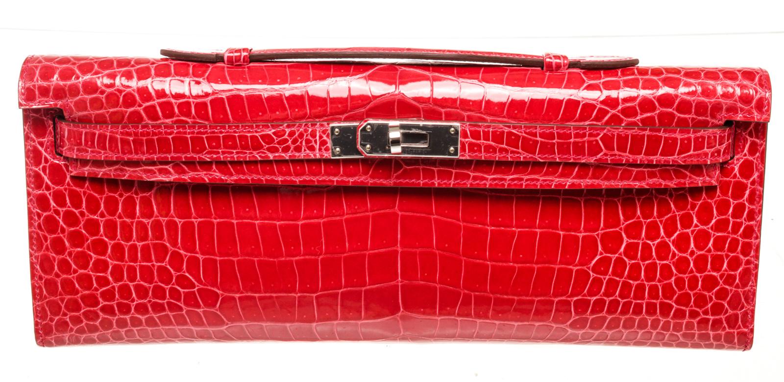 Hermes Red Electric Crocodile Kelly Cut Clutch Bag with leather, gold-toneÂ hardware, trim leather, interiorÂ slip pocketÂ and turn lockÂ closure.

50598MSC