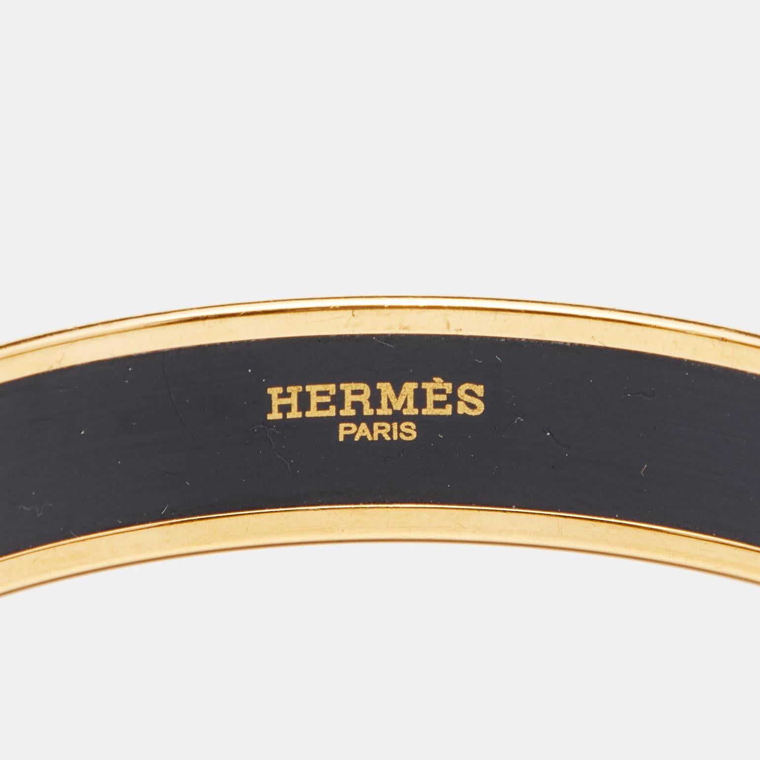 A classic Hermes bangle bracelet is so simple, effortless and yet so chic and luxurious that it is worn over and over again once purchased. It never goes out of style. Constructed using gold plated metal, this bangle is beautified with red enamel