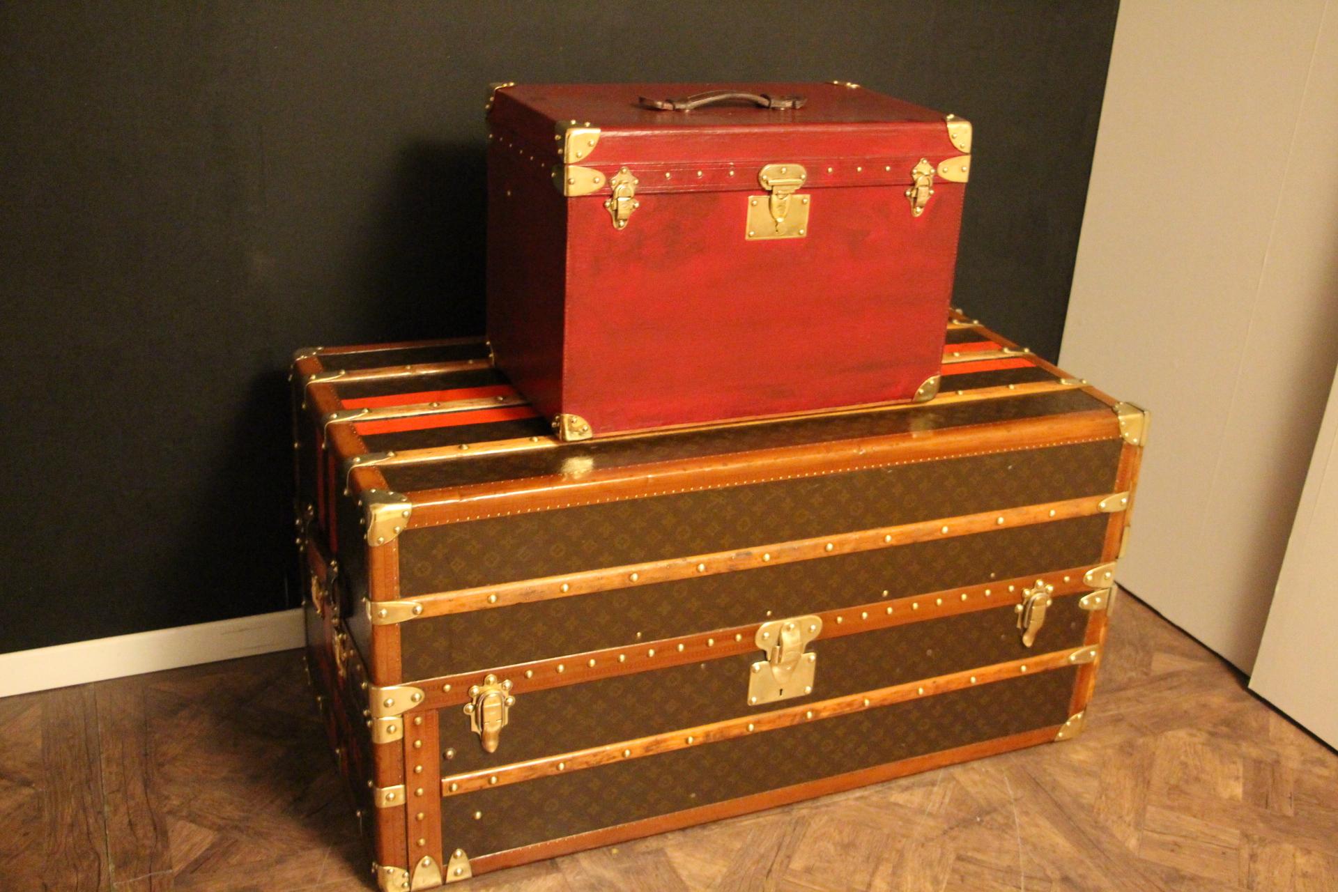 This adorable little Goyard trunk features Hermes red color canvas, solid brass corners and solid brass engraved Goyard lock and clasps. It has got a large leather handle on the top.
Its interior is all original too in cream color lining and it
