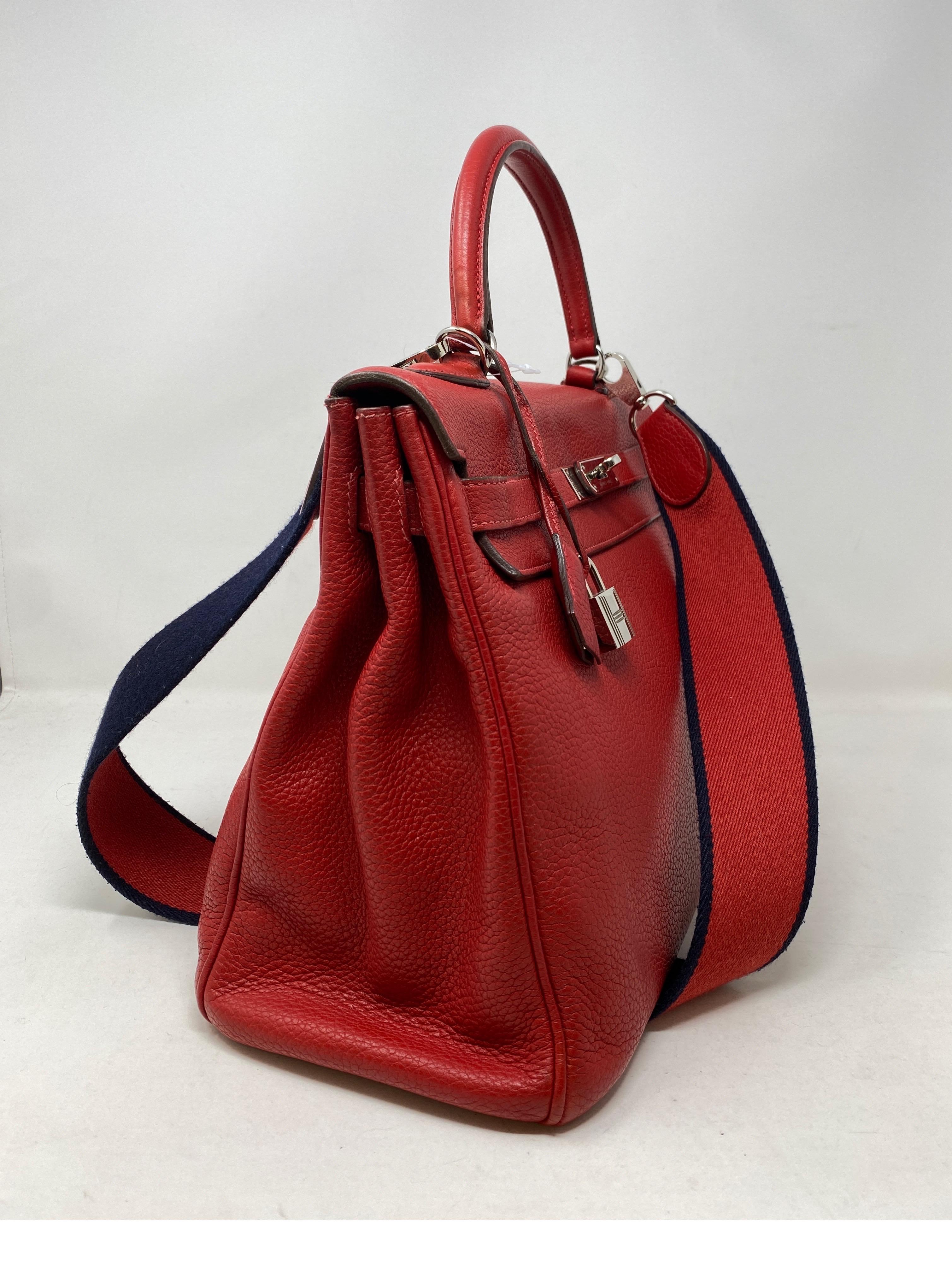Hermes Red Kelly 35 Bag. Navy and red canvas strap. Palladium hardware. Good condition. Comfortable strap. Can be worn as a shoulder bag or top handle. Includes lock, keys, clochette, and dust cover. Guaranteed authentic. 