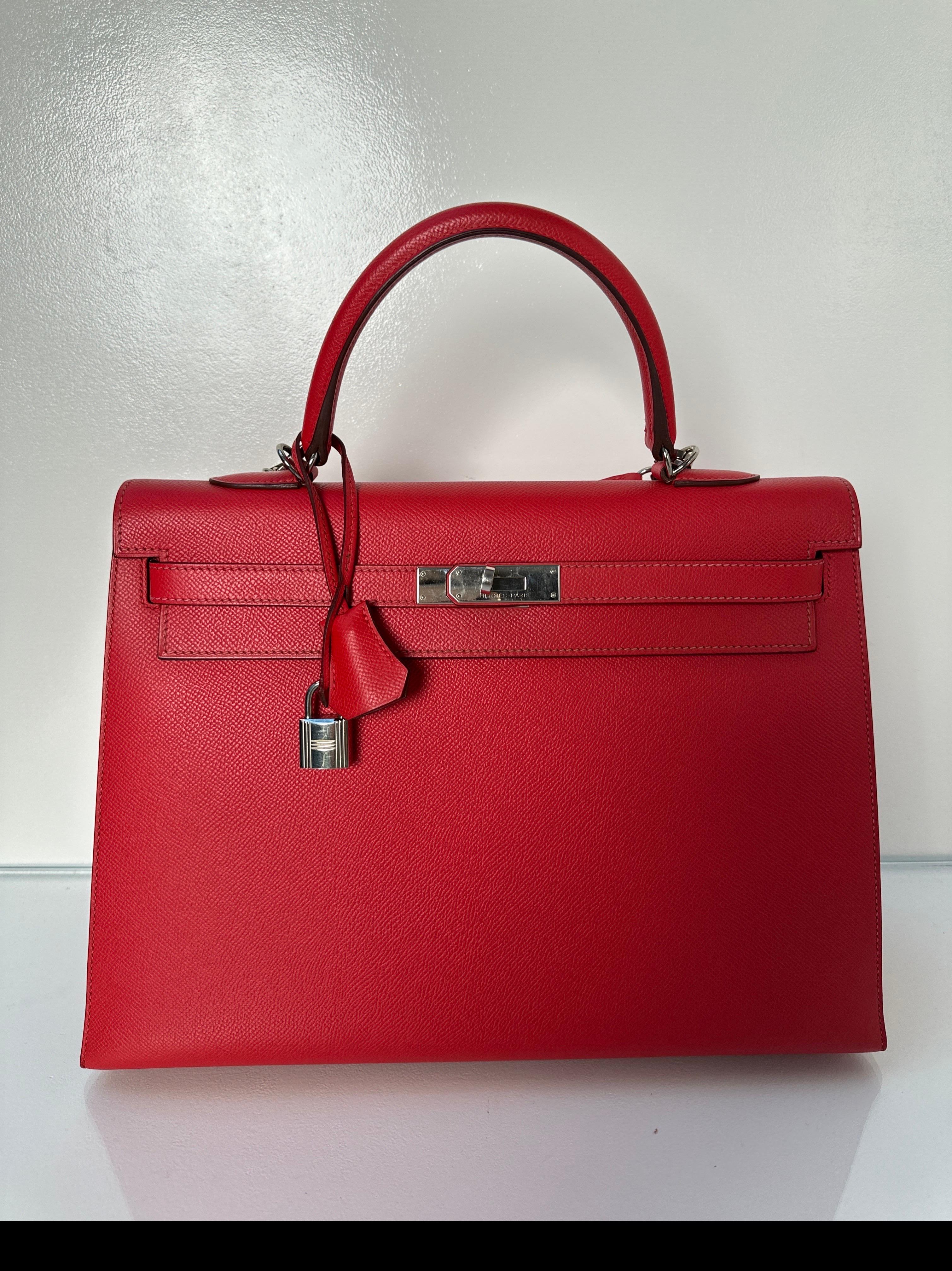 Hermes Red Kelly 35 Bag. Epsom sellier Kelly bag. Rare size in sellier. Palladium silver hardware. Interior clean. Plastic is still on hardware. Looks like new condition. Includes clochette, lock, keys, and dust bag. Guaranteed authentic. 