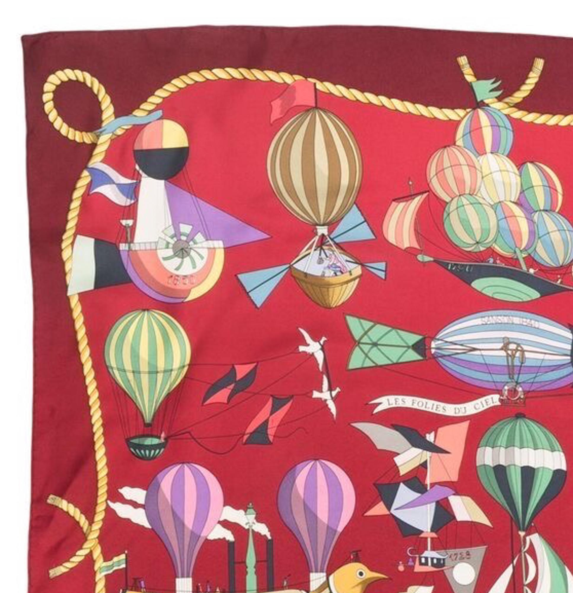 Hermes silk scarf red Les Folies du Ciel by L.Dibigeon featuring a a dark red border and a top logo signature. 
Circa 1988s 
In good vintage condition. Made in France.
35,4in. (90cm)  X 35,4in. (90cm)
We guarantee you will receive this  iconic item