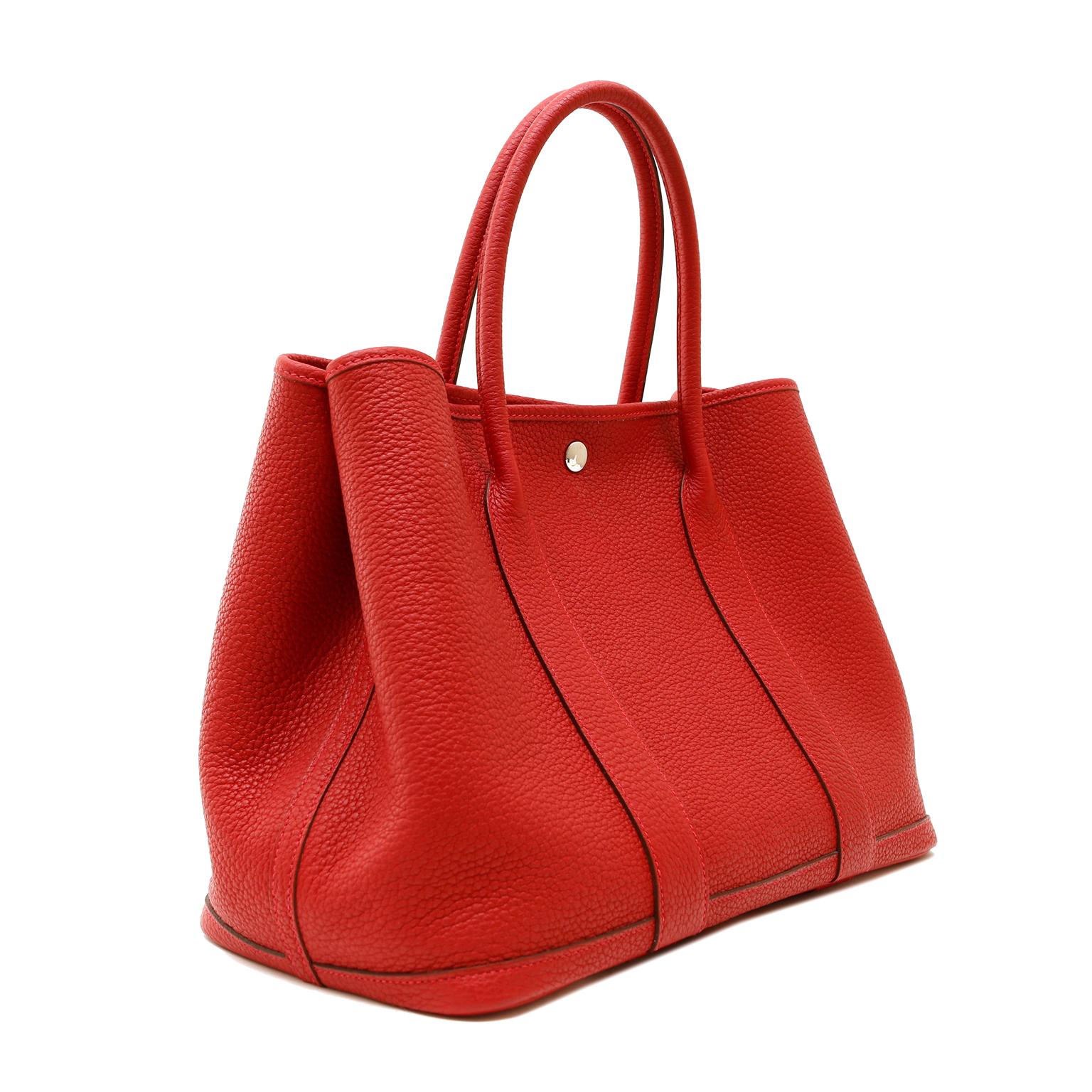 This authentic Hermès Red Negonda Leather Garden Party GM Tote is in pristine condition.   Perfectly scaled for everyday, the Garden Party easily carries everything in high style.  
Vivid lipstick red Negonda leather is textured and durable with a