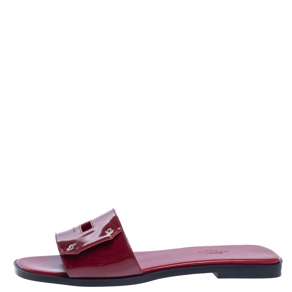 You'll find excuses to wear these slide sandals from Hermes that are all about comfort and effortless style! These sandals are crafted from patent leather with a cutout design on the vamps that resembles the iconic Kelly buckle. The pair is complete