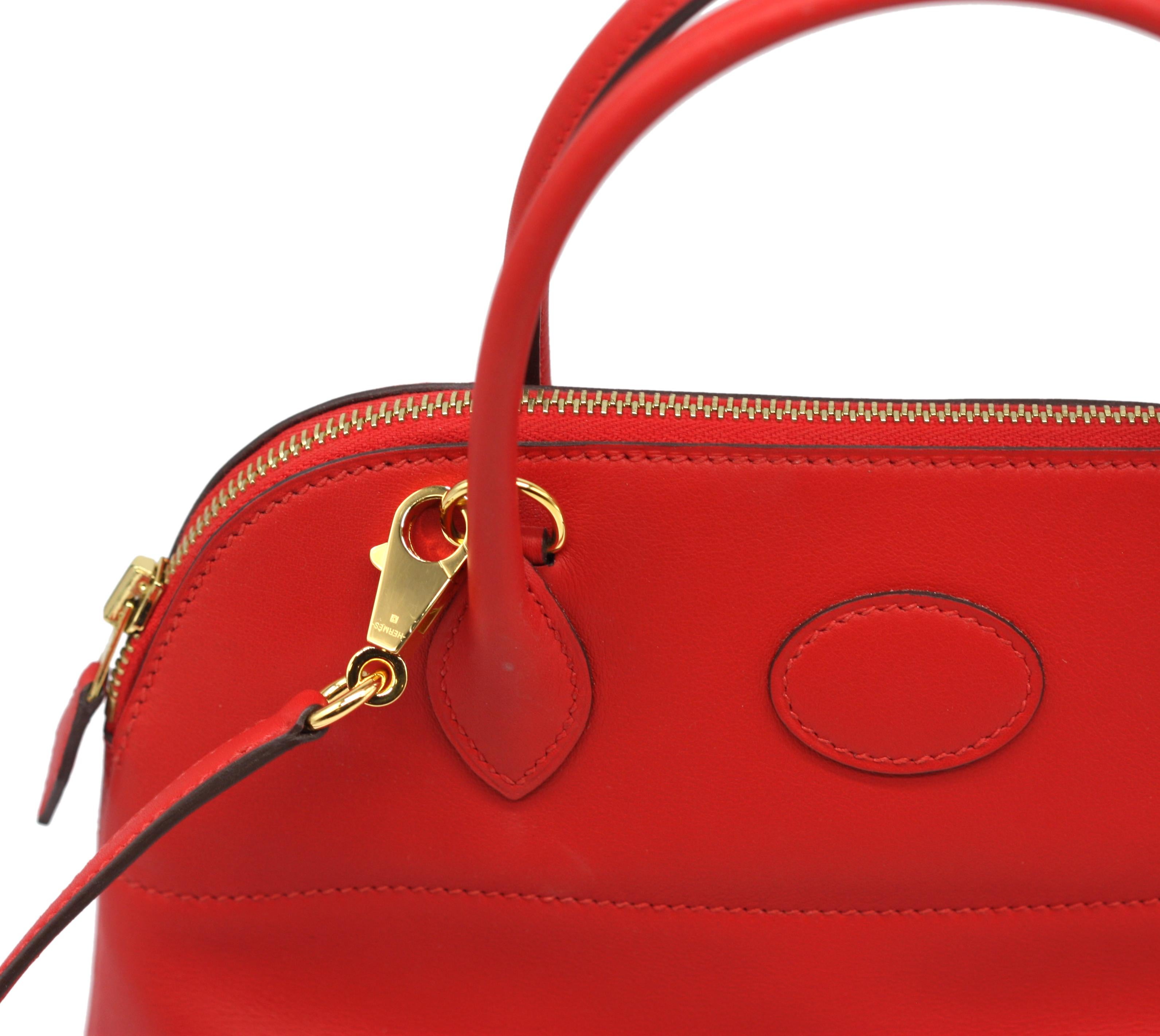
Hermes Red Swift Leather Bolide 27
Double-rolled loop handles, gold-toned hardware, red leather shoulder strap, with red leather-lined interior with a slit pocket.
Height, including handles 12 in., Width 10.5 in., Depth 4 in.
Condition Report
Good