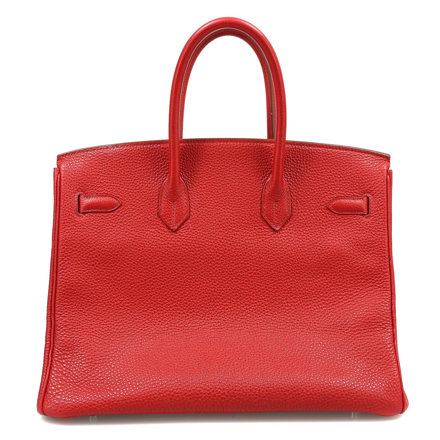 This authentic Hermès Red Togo 35 cm Birkin is in better than excellent condition.    Hand stitched by skilled craftsmen, wait lists of a year or more are common for the Hermès Birkin. They are considered the ultimate in luxury fashion. Iconic