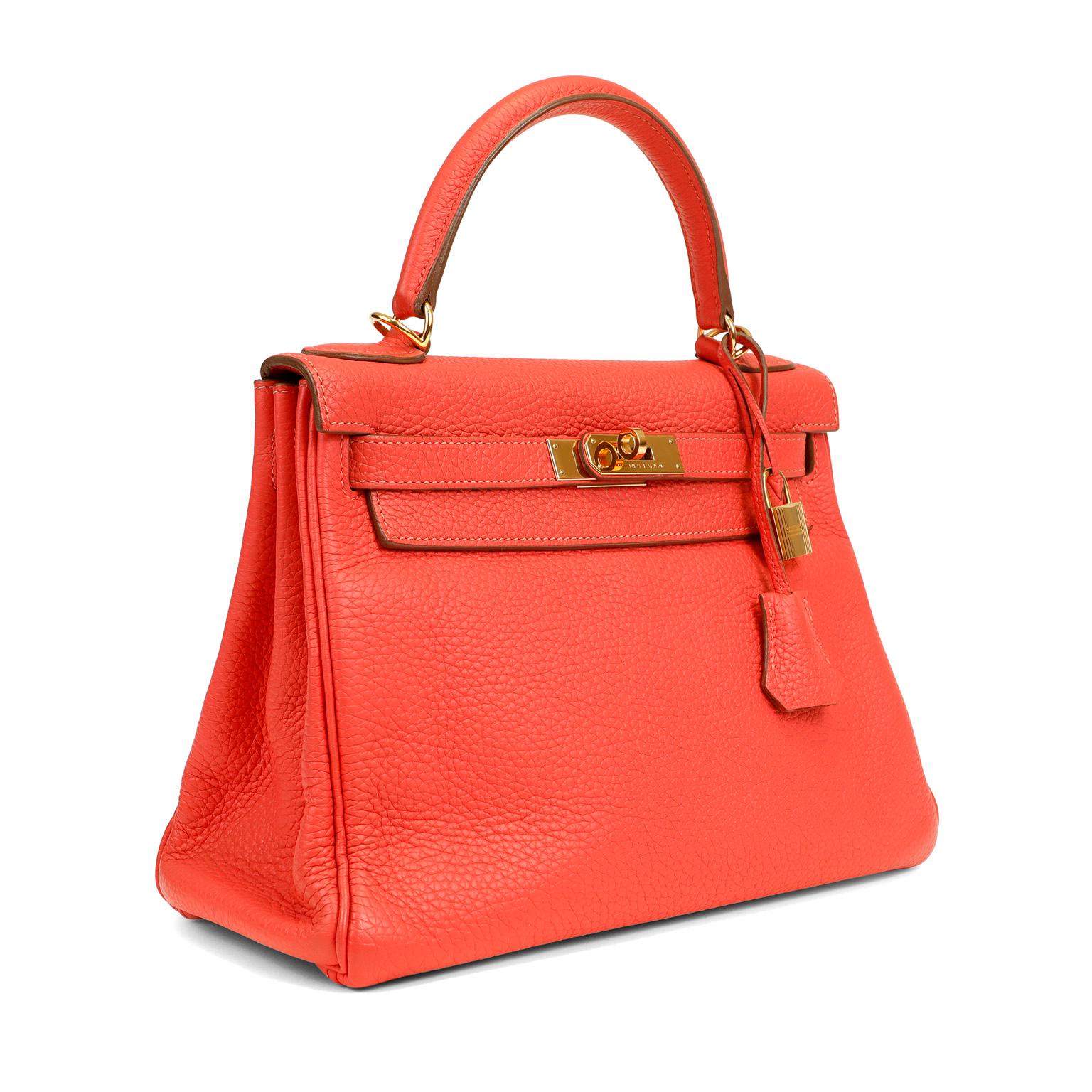 This authentic Hermès Red Togo Leather 28 cm Kelly Bag is in good previously owned condition.    Hermès bags are considered the ultimate luxury item worldwide.  Each piece is handcrafted with waitlists that frequently exceed a year.  The streamlined