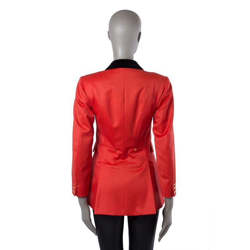 Hermes long blazer in black and red wool (100%). With Velvet notch collar, two front flap pockets, two golden buttons on the back, and two back slits. Closes with golden buttons on the front and cuffs. Lined in red polyester (100%). Has been worn