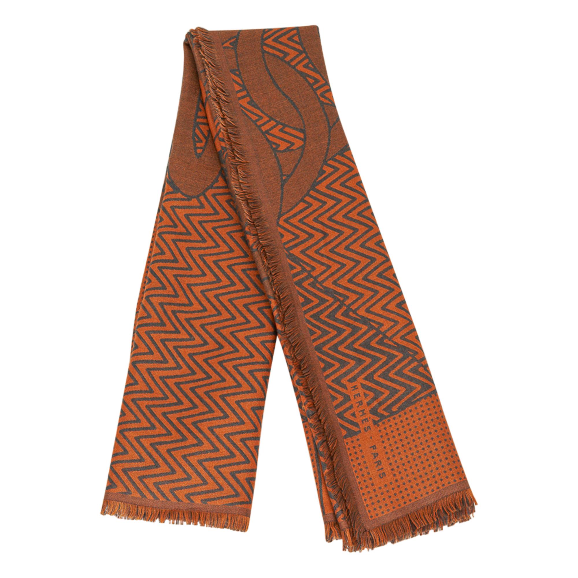 Guaranteed authentic Hermes Harnais De Cabriolet Reversible 100 Cashmere and Silk scarf.  
The double sided weave reverses the colours for you to enjoy to wear either way.
Designed by Cyrille Diatkine.
Beautiful and subtle in Orange and Gris.
Small