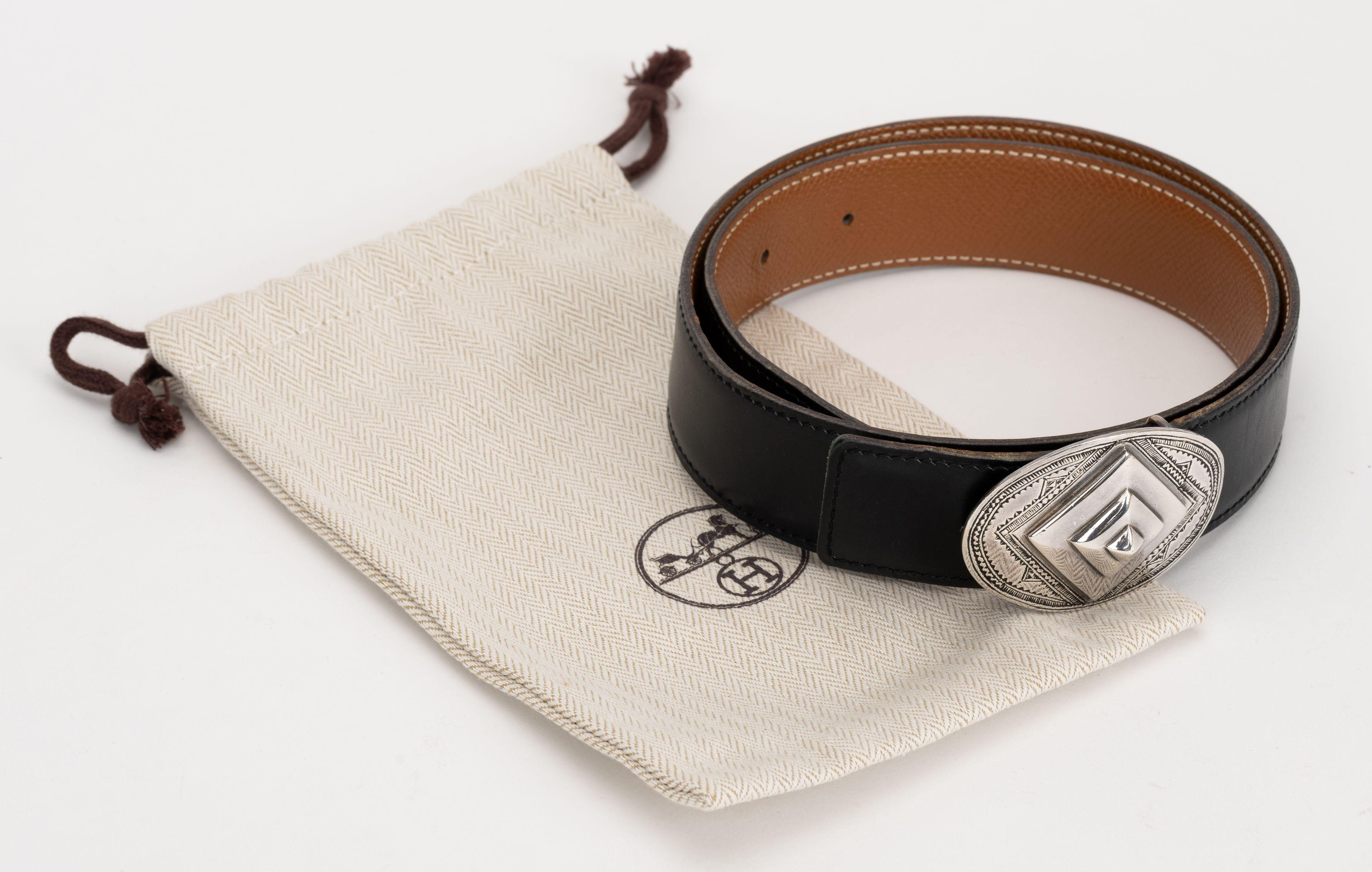 Hermès limited edition belt with handmade Tuareg sterling silver buckle. Handcrafted by Tuareg tribes in the Sahara Desert. Dated O in a box for 2011. Reversible belt in black Swift and gold togo Belt size: 65cm. Comes with original dust cover.