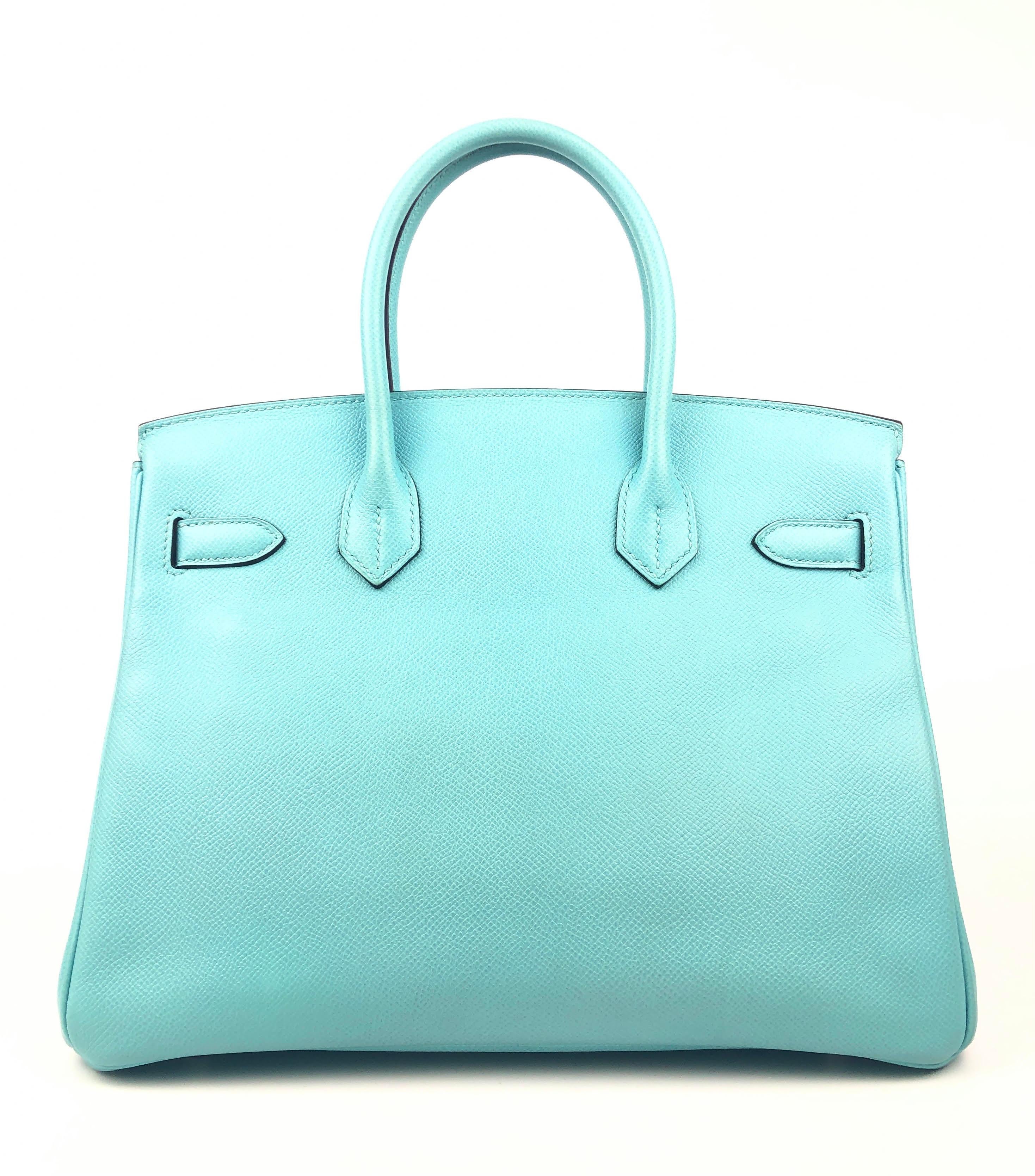 This authentic Hermès Robin’s Egg Blue Epsom 30 cm Birkin is in pristine unworn condition; the protective plastic is still intact on the hardware.    Considered the ultimate luxury item, the Hermès Birkin is stitched by hand. Waitlists are
