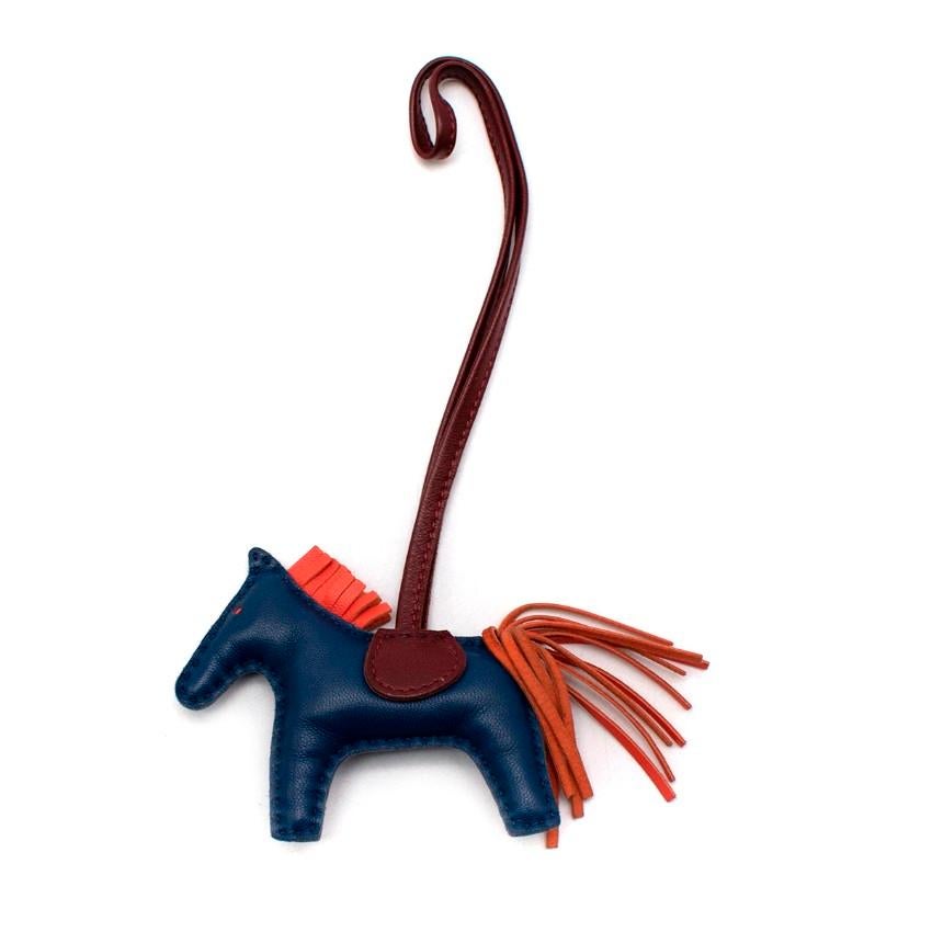 Hermes Rodeo Leather Horse Bag PM Charm
 

 - Playful and bright all-leather bag charm in the shape of a horse
 - Dark navy blue body, with bright orange mane and tail, and burgundy saddle with strap
 - 3-D design
 

 Materials:
 Leather
 

 Made in