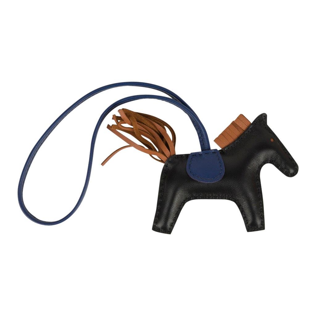 Mightychic offers an Hermes Rodeo PM bag charm in Black, Blue Sapphire and Gold.
Charming and playful she easily adorns a myriad bag colors in your fabulous collection. 
Skin is Milo lambskin.
Signature HERMES PARIS MADE IN FRANCE is stamped under
