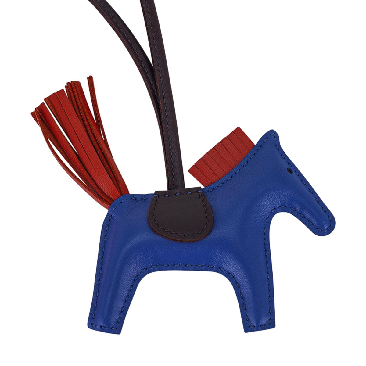 Mightychic offers an Hermes Grigri Pegase Rodeo PM featured in Bleu de France, Cornaline and Rouge Sellier.
Charming and playful she easily adorns a myriad bag colours in your fabulous collection. 
Leather is lambskin Milo.
Signature HERMES PARIS