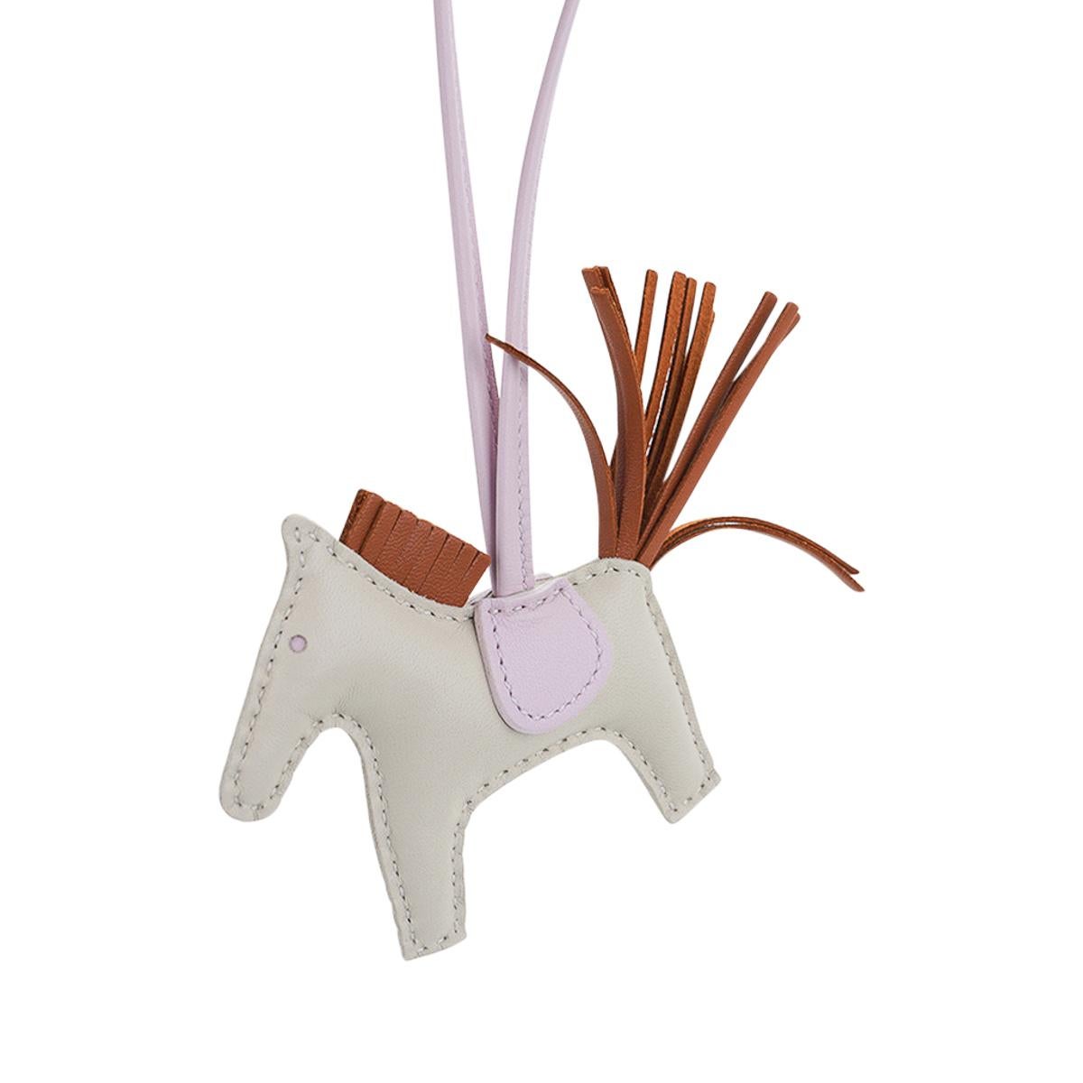 Mightychic offers an Hermes PM Rodeo bag charm featured in Craie, Mauve Pale and Gold.
Charming and playful she easily adorns a myriad bag colours in your fabulous collection.
Skin is Milo lambskin.
Signature HERMES PARIS MADE IN FRANCE is stamped