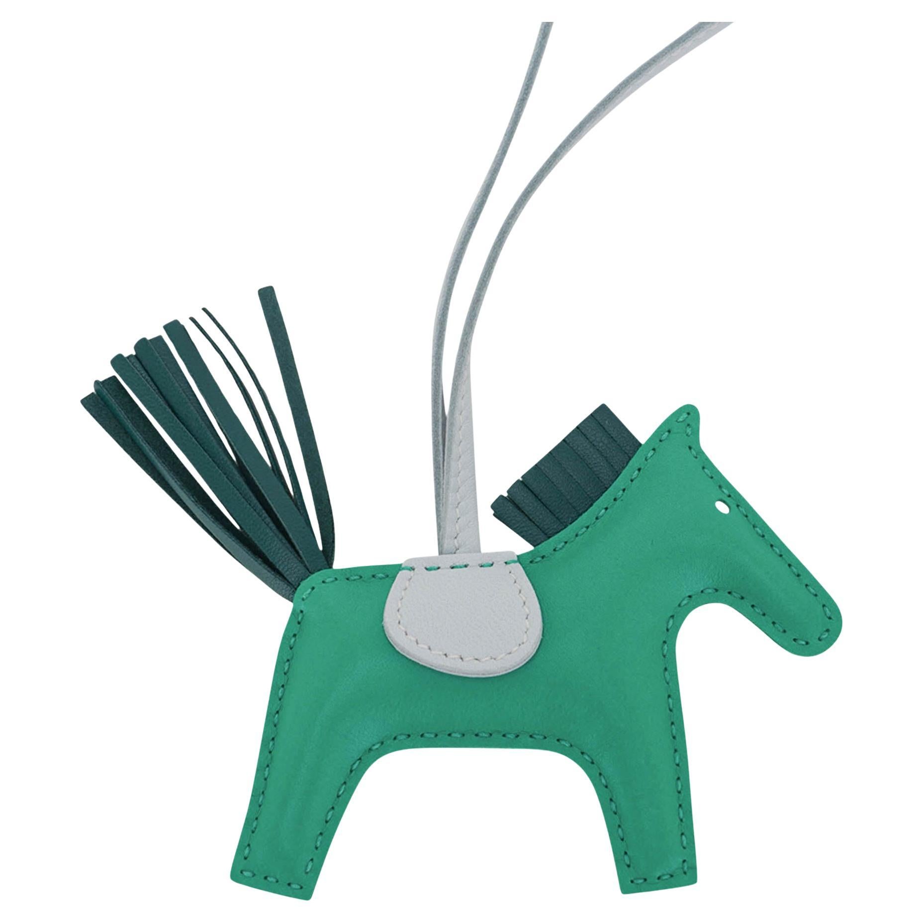 Mightychic offers an Hermes PM Rodeo bag charm featured in Menthe, Malachite and Bleu Brume.
Charming and playful she easily adorns a myriad bag colors in your fabulous collection.
Skin is Milo lambskin.
Signature HERMES PARIS MADE IN FRANCE is