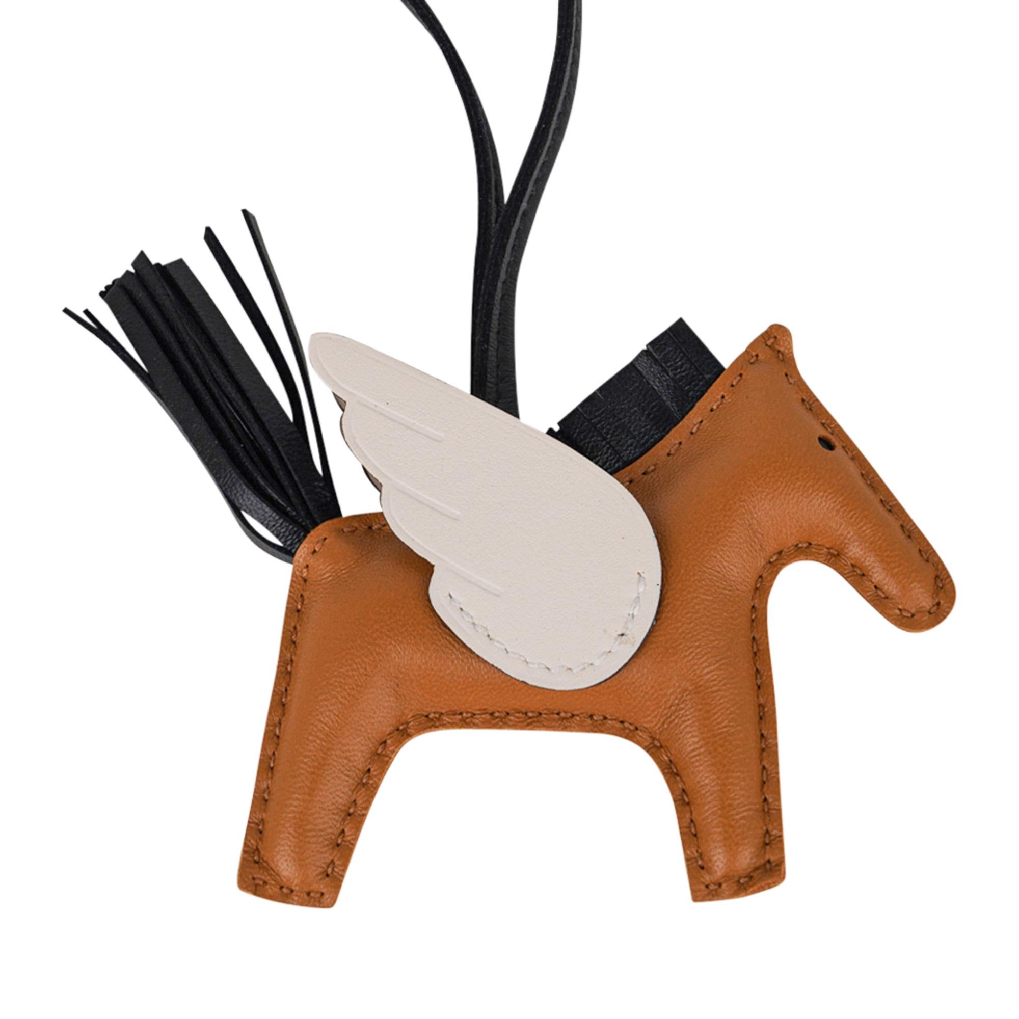 Mightychic offers a guaranteed authentic coveted Hermes Pegase Rodeo PM bag charm featured in Sesame, Nata and Black.
Charming and playful she easily adorns a myriad bag colours in your fabulous collection.
Skin is Milo lambskin.
Signature HERMES