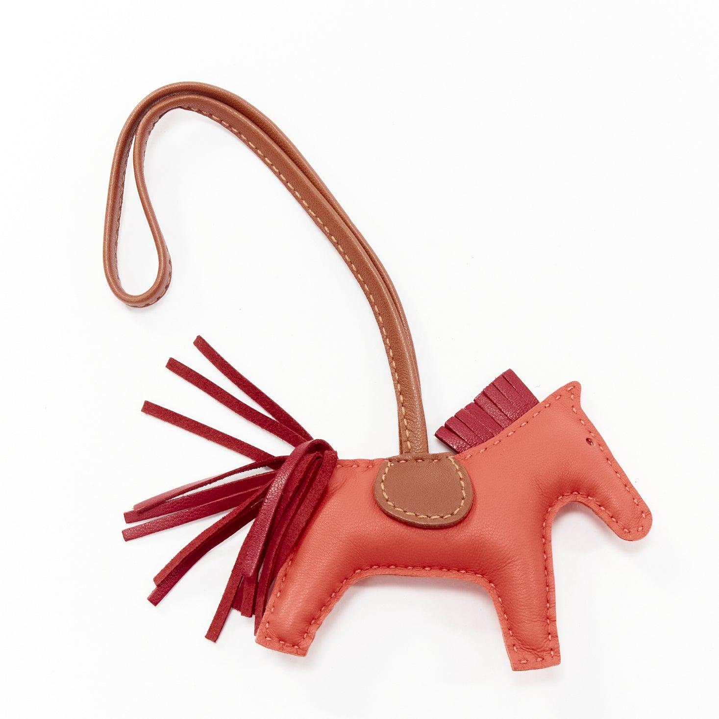 HERMES Rodeo PM red leather brown trim fringed tail horse bag charm
Reference: AAWC/A01027
Brand: Hermes
Model: Rodeo PM
Material: Leather
Color: Red, Brown
Pattern: Solid
Closure: Strap
Lining: Brown Leather
Made in: France

CONDITION:
Condition: