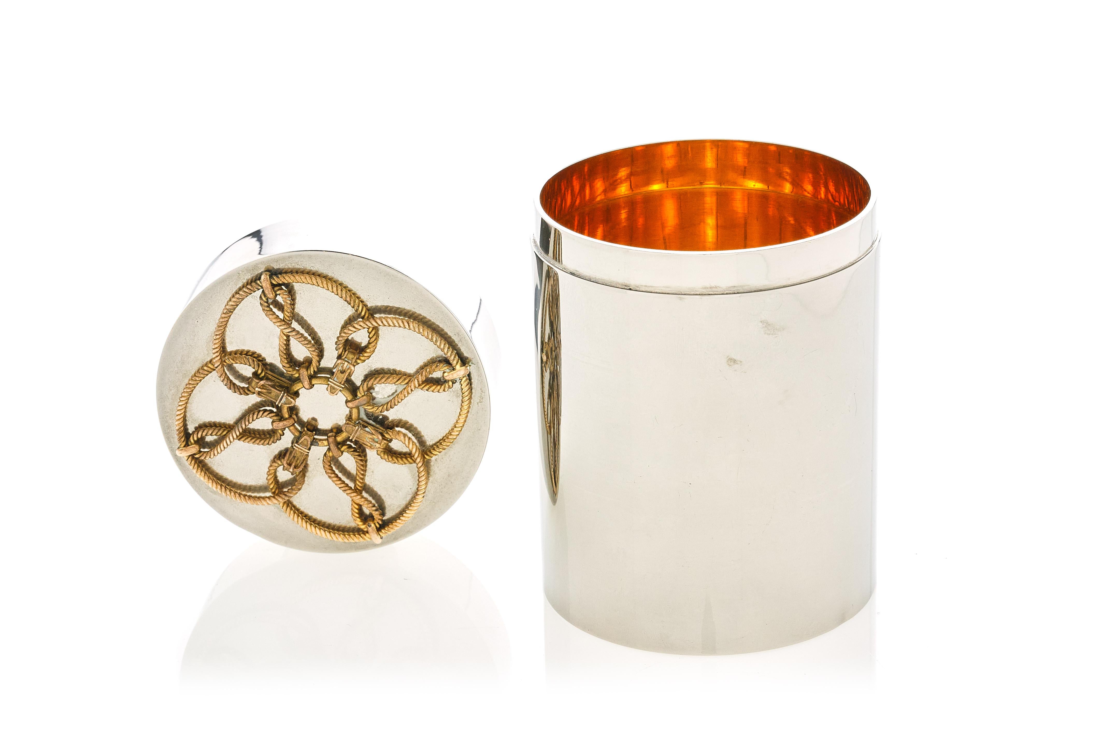 A large cylinder box by Hermes, featuring a gilt-interior with a figural rope top,

1960s.

Measures: 4.25
