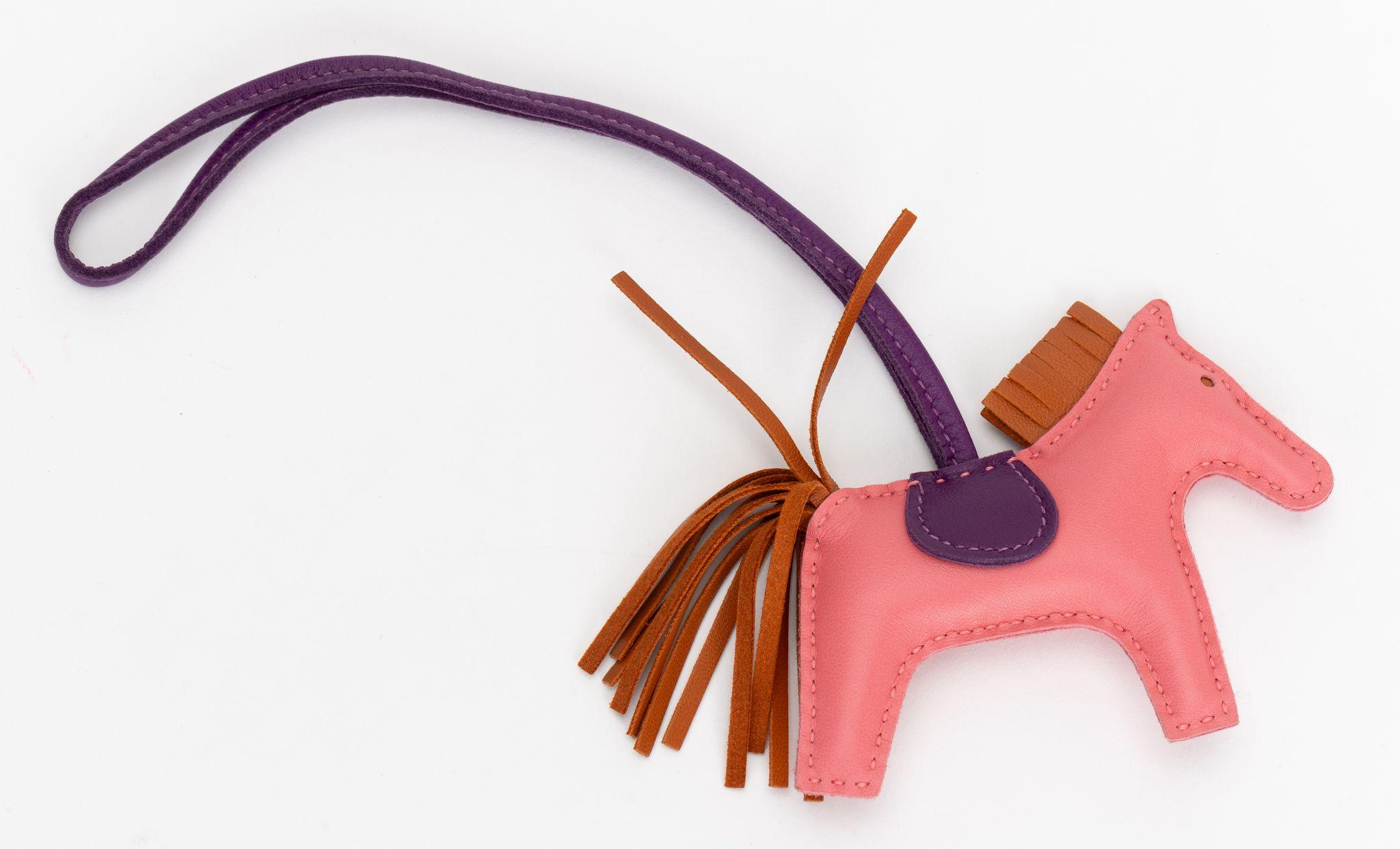 Hermès grigri rodeo bag charm. Size: PM (small). Combination of rose azalee and anemone leather. Comes with original dust cover, excellent condition. Marked: Hermés Paris Made in France.