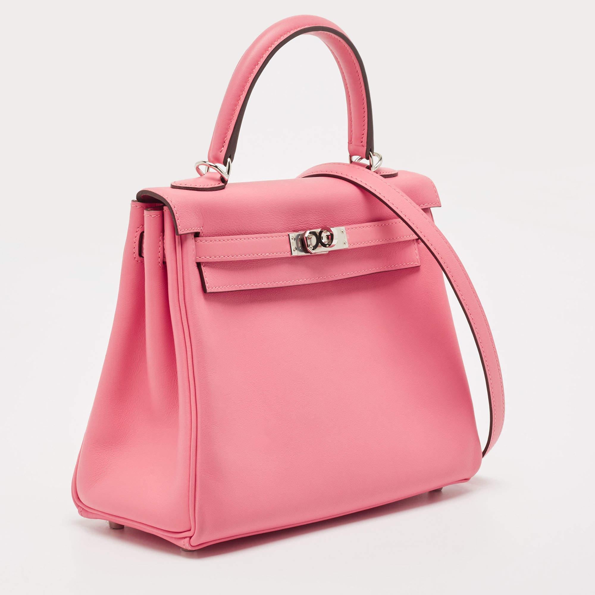 Powered by a rich history and impeccable hand craftsmanship, the Hermès Kelly is a beautiful work of art. Carefully hand-stitched to perfection. This Swift leather Kelly Retourne 25 has palladium-finished hardware. Retourne has a more casual look