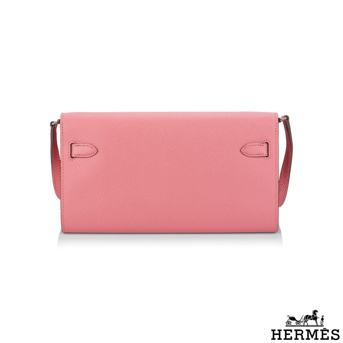 A Chic And Exquisite Hermès Kelly Wallet To Go. The exterior of this Kelly features rose confetti epsom leather with palladium hardware and has tonal stitching, two straps with front toggle closure and removable crossbody strap.

The interior is