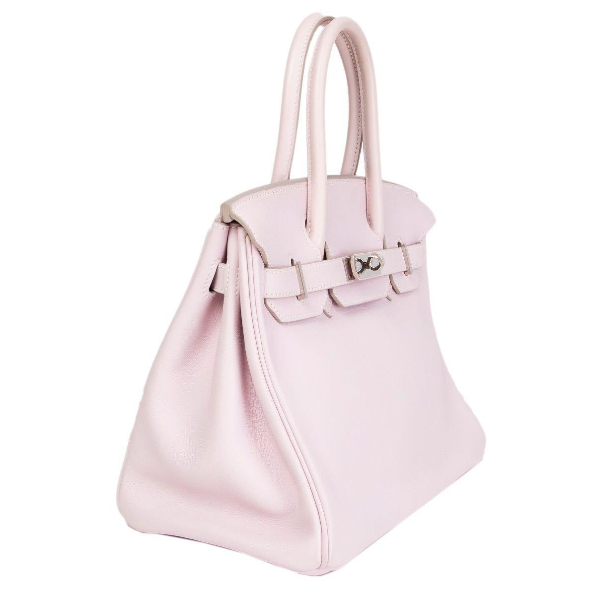 Hermes 'Birkin 30' in Rose Dragee (pale pink) Veau Swift leather. Lined with an open pocket against the front and a zipper pocket against the back. Has been carried a very faint rub mark from the lock, and very slight yellowing to the handles.