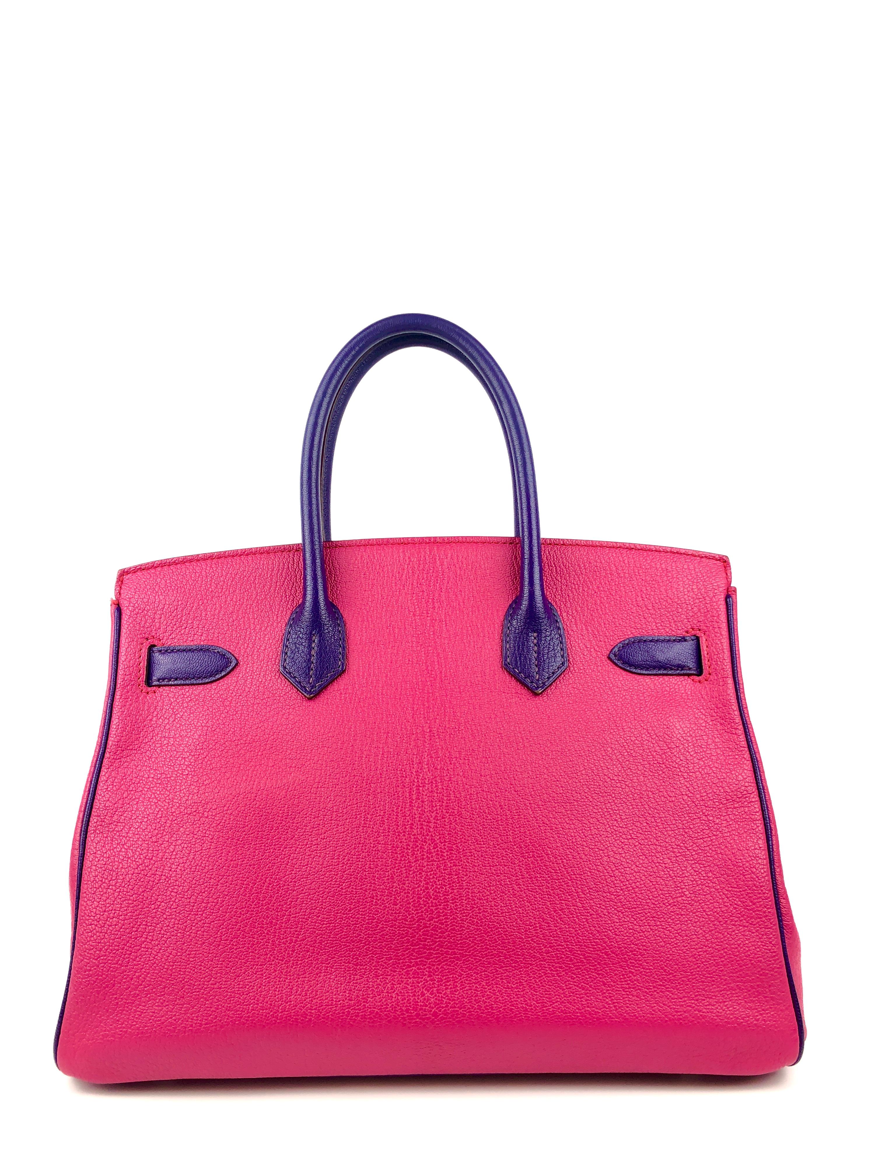 This authentic Hermès Rose Extreme and Iris Chevre Horseshoe Birkin is in pristine condition.  Specially ordered as indicated by the horseshoe stamp, this special Birkin is one-of-a-kind.
Shocking pink chevre leather (goat hide) is extremely durable