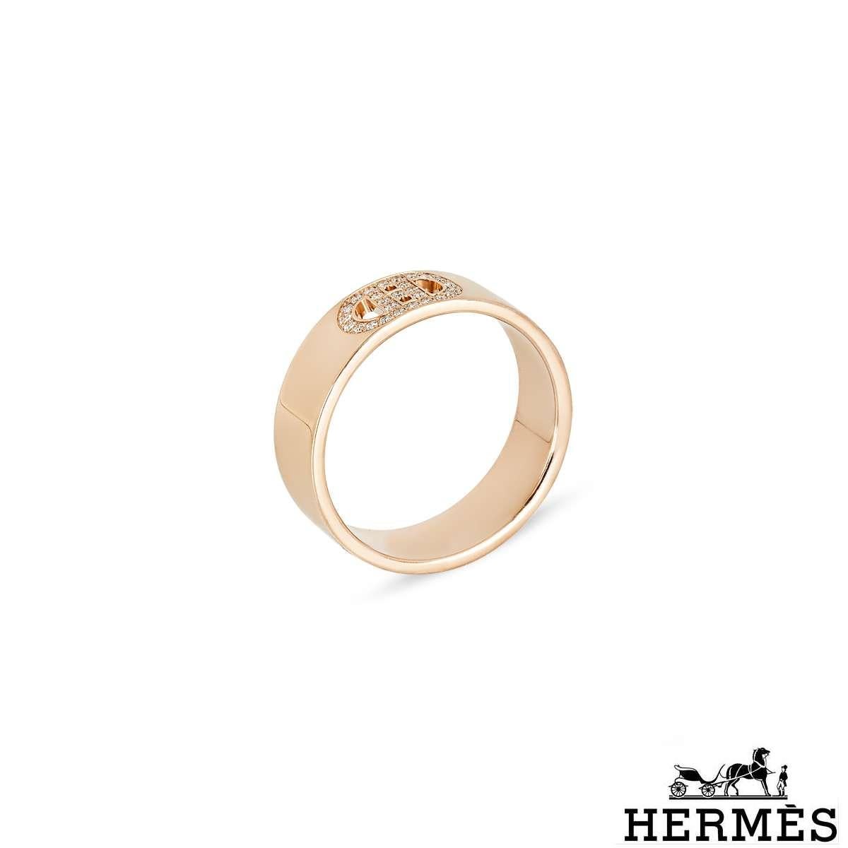 An 18k rose gold diamond ring by Hermes from the H d'Ancre collection. The ring is set with the iconic 'H' buckle motif pave set with 27 round brilliant cut diamonds with a weight of 0.07ct. The ring measures 5mm in width and is a size UK L - EU 51
