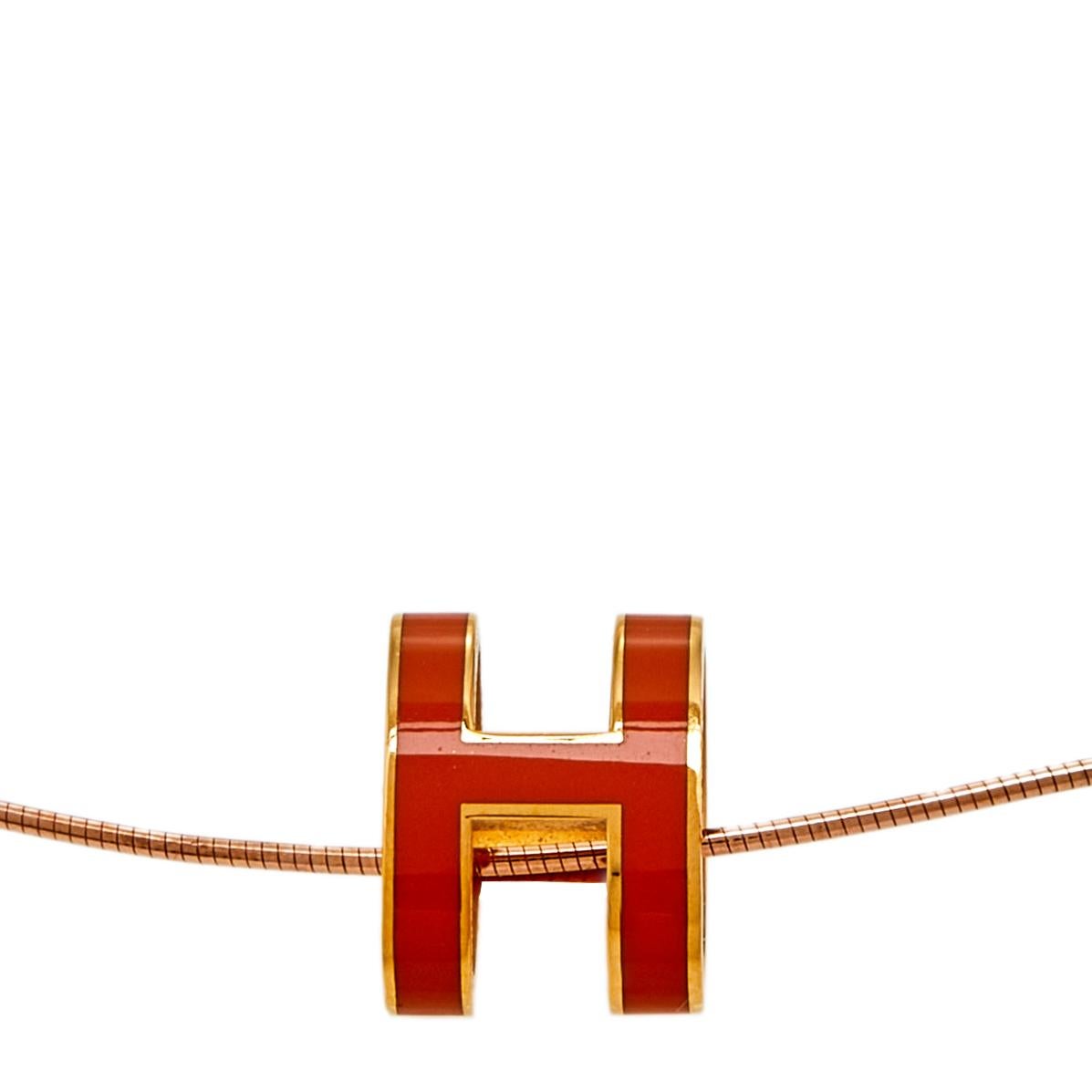 This stunning rose gold-plated metal necklace by Hermès is minimal and effortlessly stylish to pair with any outfit. Featuring a signature logo H-shaped pendant tinted with orange enamel, this Pop H necklace is a practical and simple piece that can