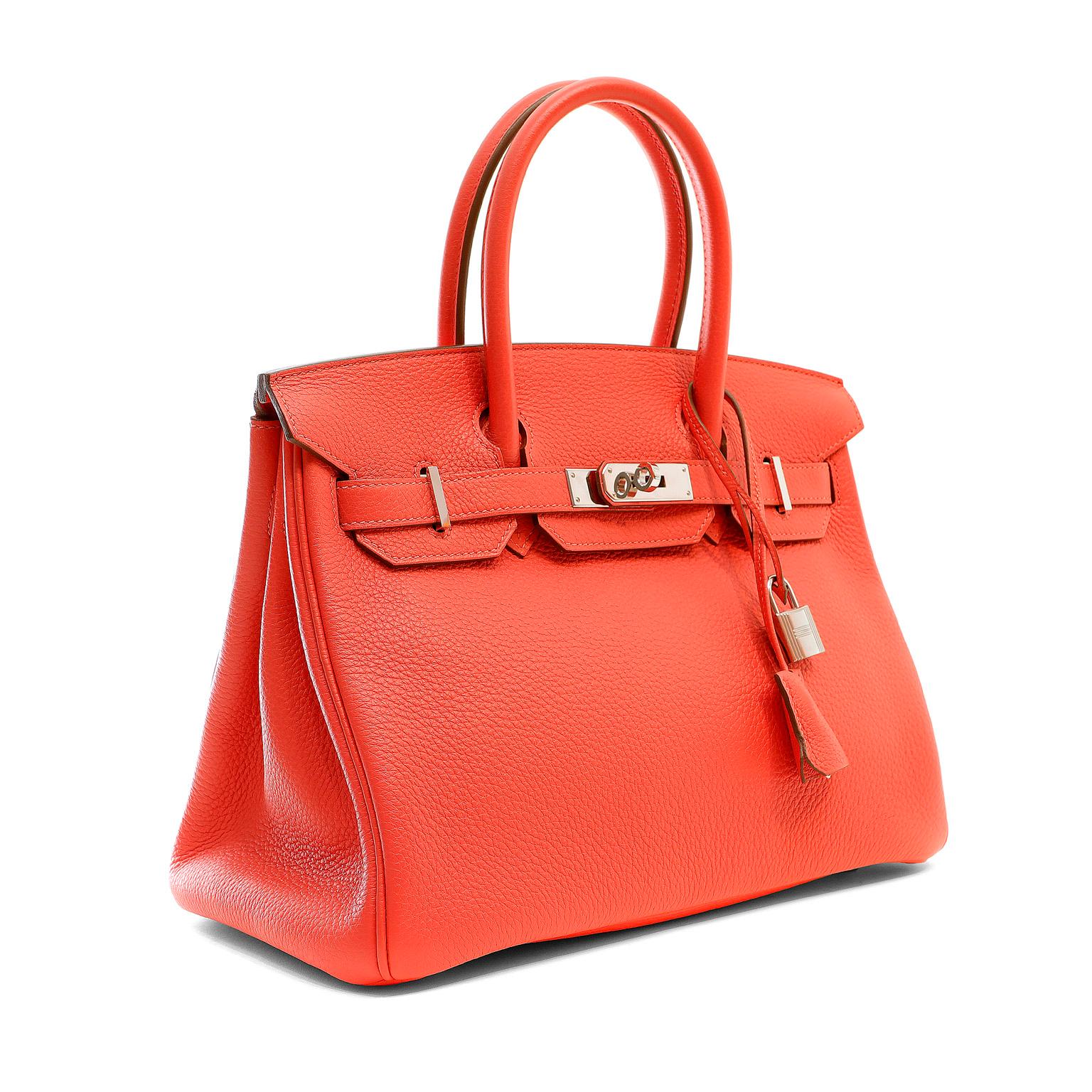 This authentic Hermès Rose Orange Togo 30 cm Birkin is in pristine condition.    Hand stitched by skilled craftsmen, wait lists of a year or more are common for the Hermès Birkin. Perfectly paired with Palladium hardware, this vibrant pinky orange