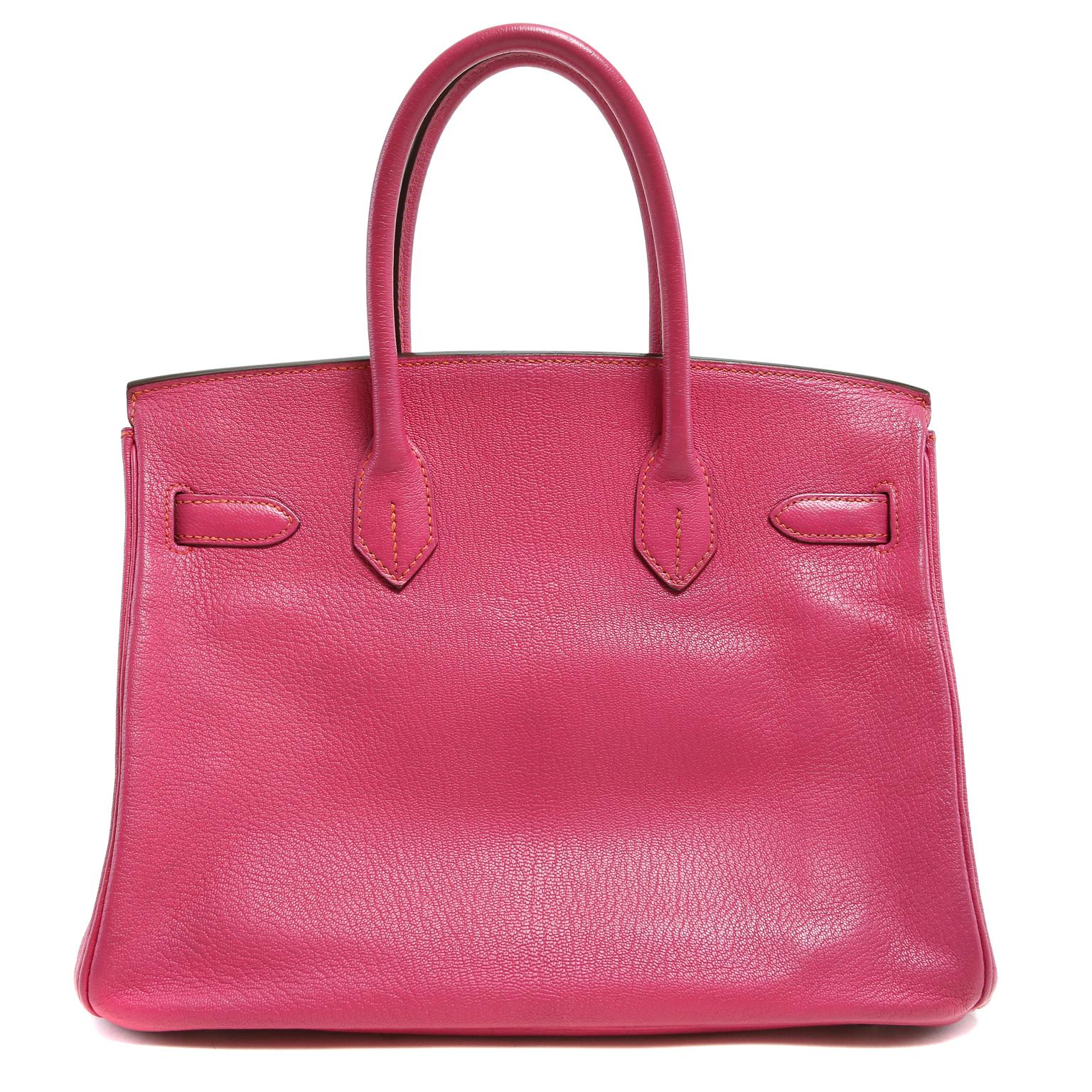 This authentic Hermès Rose Shocking Chevre Leather 30 cm Birkin Bag is new with the plastic intact on the hardware.    A limited edition piece, the horseshoe symbol next to the Hermès stamp indicates a special order.  This service is only available