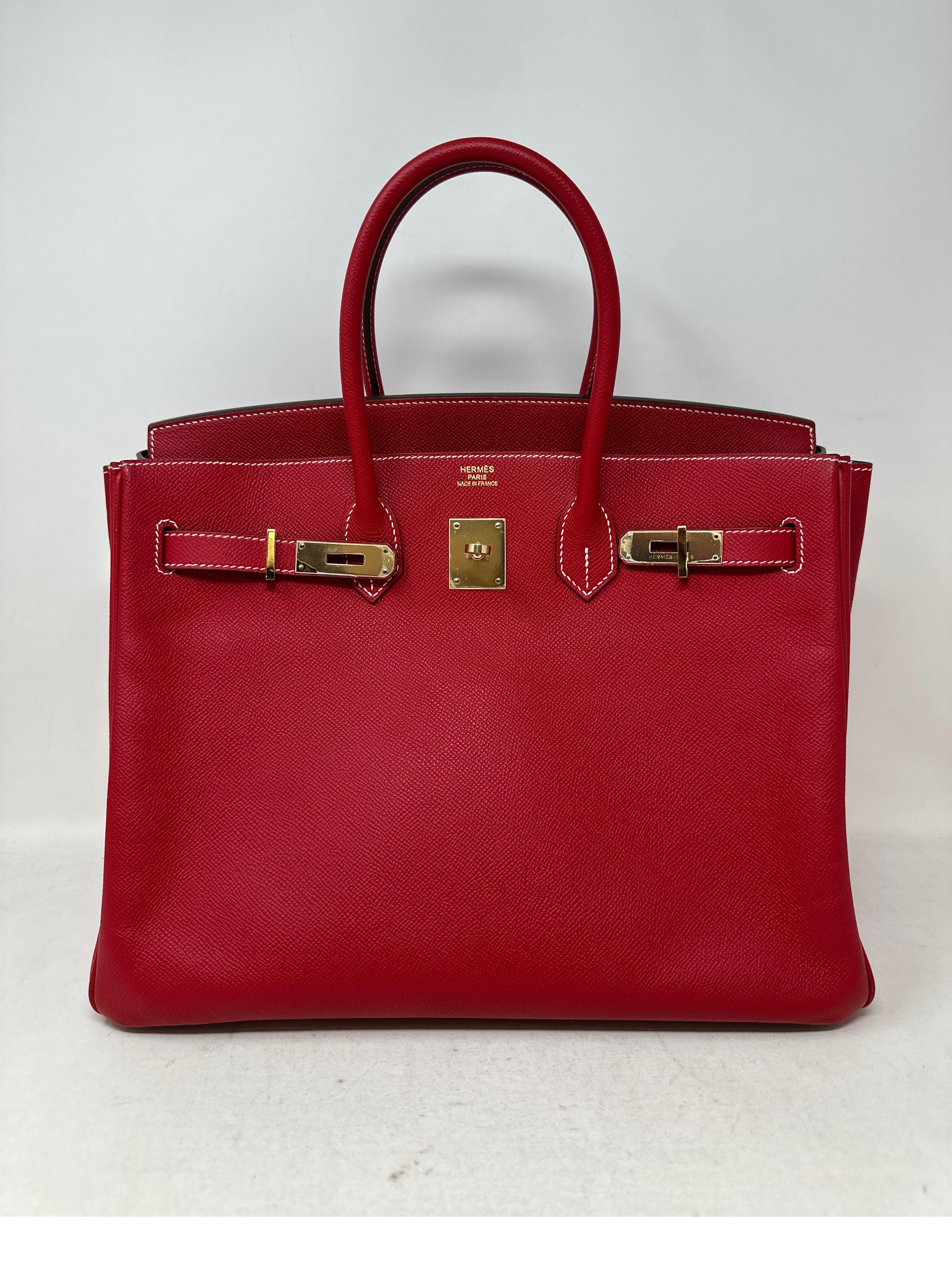 Hermes Rouge Casaque Candy Birkin 35 Bag. Red exterior and blue thalasa interior. Excellent condition. Plastic still on hardware. Gold hardware. Epsom leather. One of the most desired red colors made by Hermes. Includes clochette, lock, keys, and