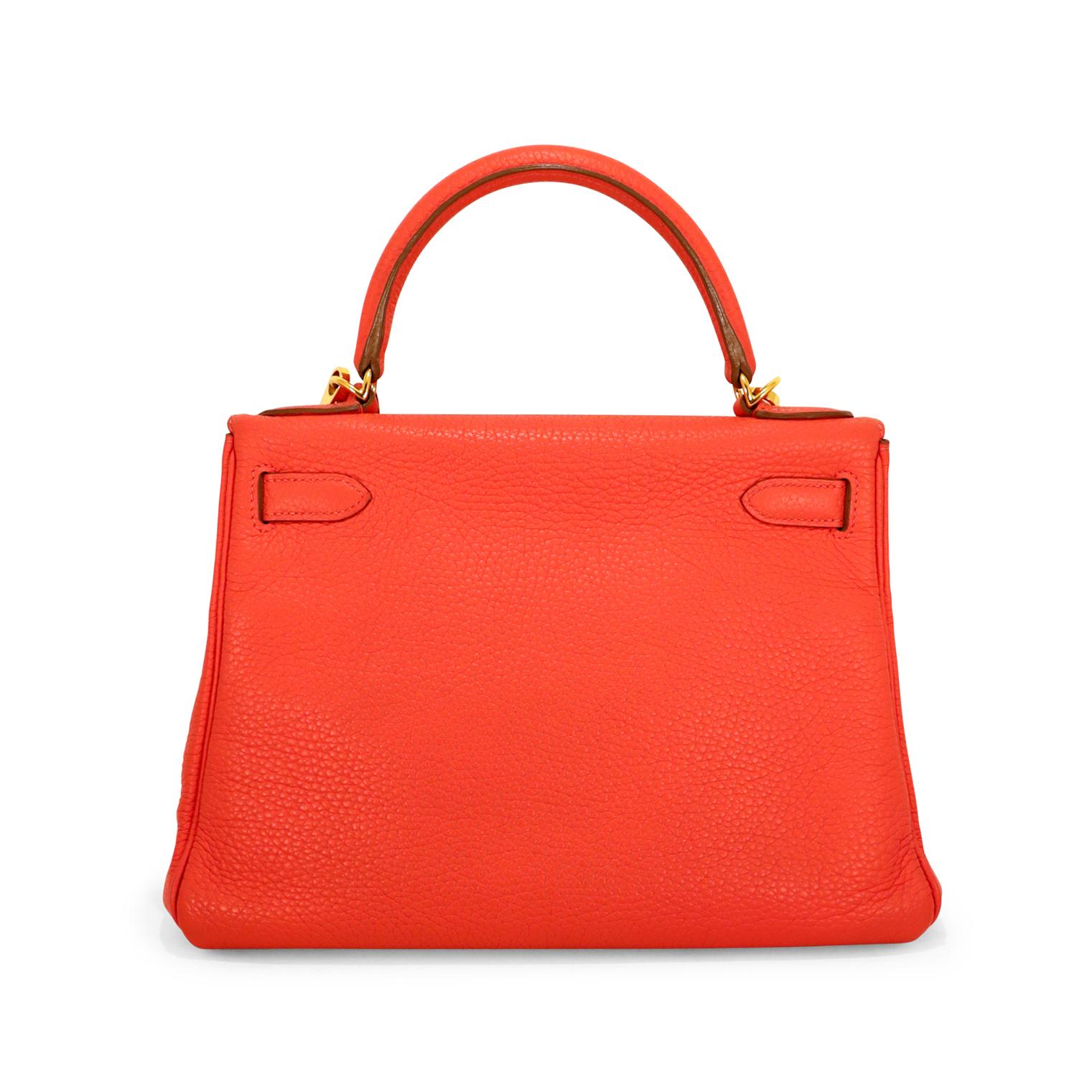 This authentic Hermès Rouge Casaque Togo Leather 28 cm Kelly Bag is in excellent condition.   Hermès bags are considered the ultimate luxury item worldwide.  Each piece is handcrafted with waitlists that can exceed a year or more.  The streamlined